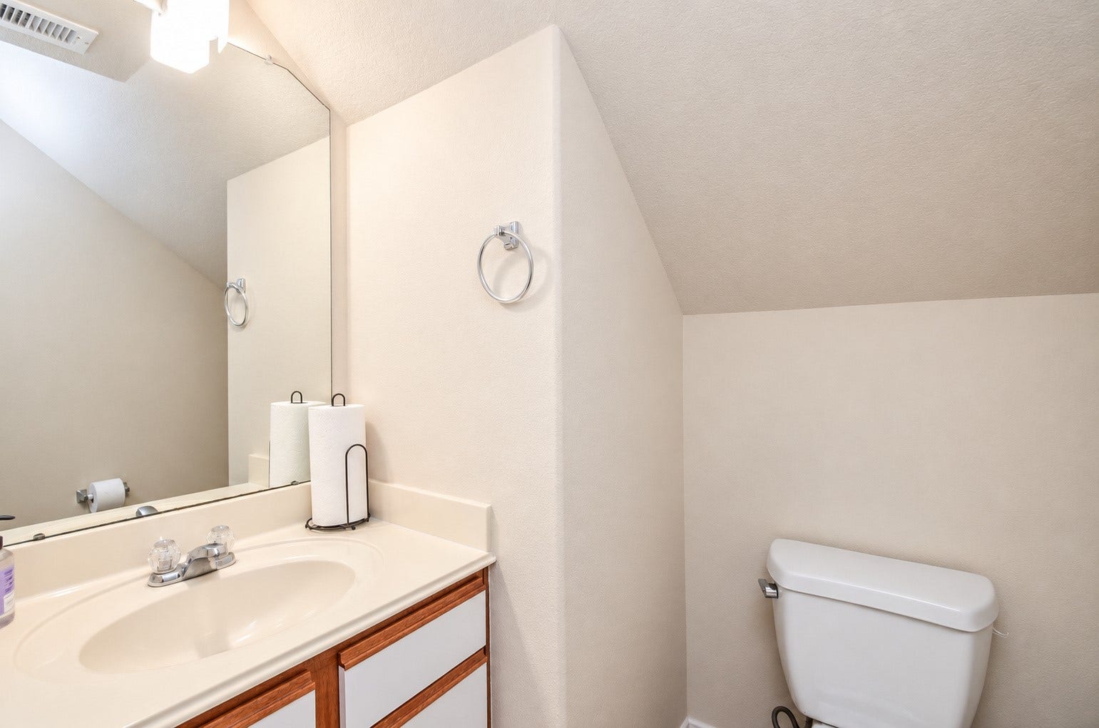 5031 Grove Square Court, Katy, TX 77449 Convenient first-floor half bath featuring a vanity with ample counter space, large mirror and neutral finishes.