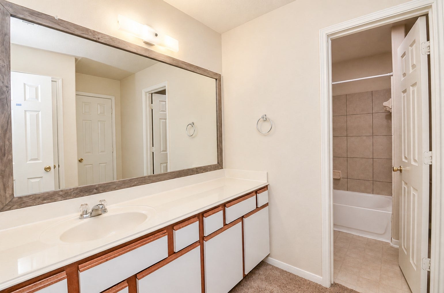 5031 Grove Square Court, Katy, TX 77449 Spacious upstairs full bathroom featuring an extended vanity, large framed mirror and separate tub/shower area.