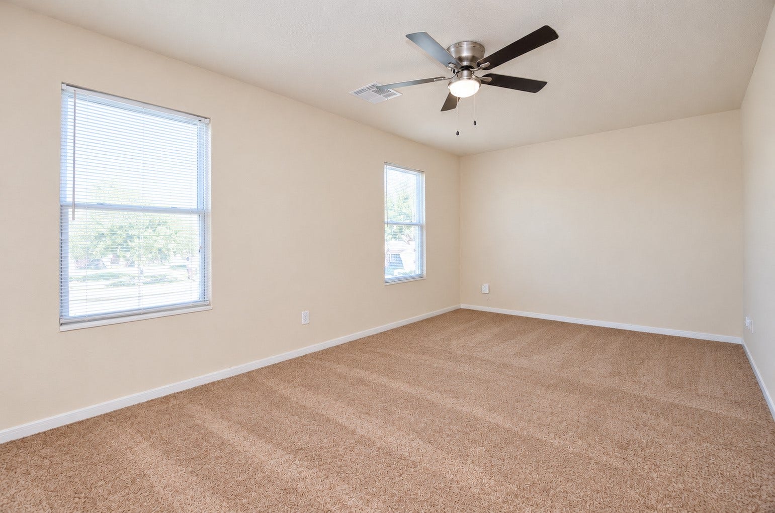 5031 Grove Square Court, Katy, TX 77449 Spacious upstairs game room featuring neutral carpeting, a ceiling fan and windows providing natural light.