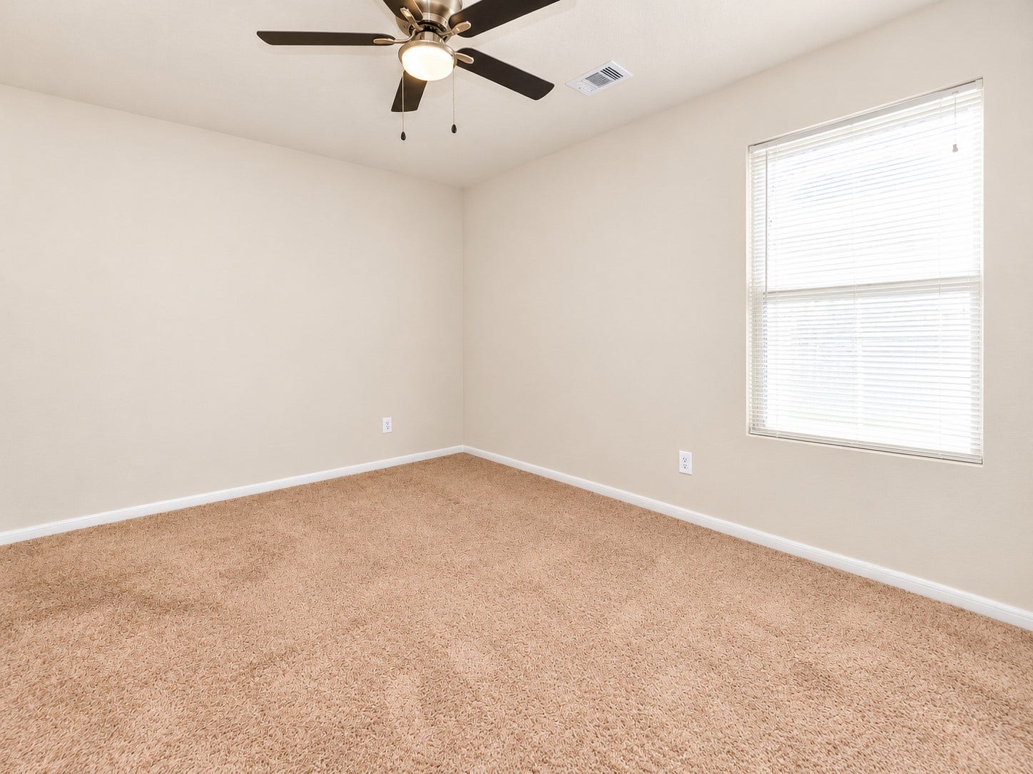 5031 Grove Square Court, Katy, TX 77449 Third bedroom upstairs featuring neutral carpeting, a ceiling fan and a large window providing natural light.