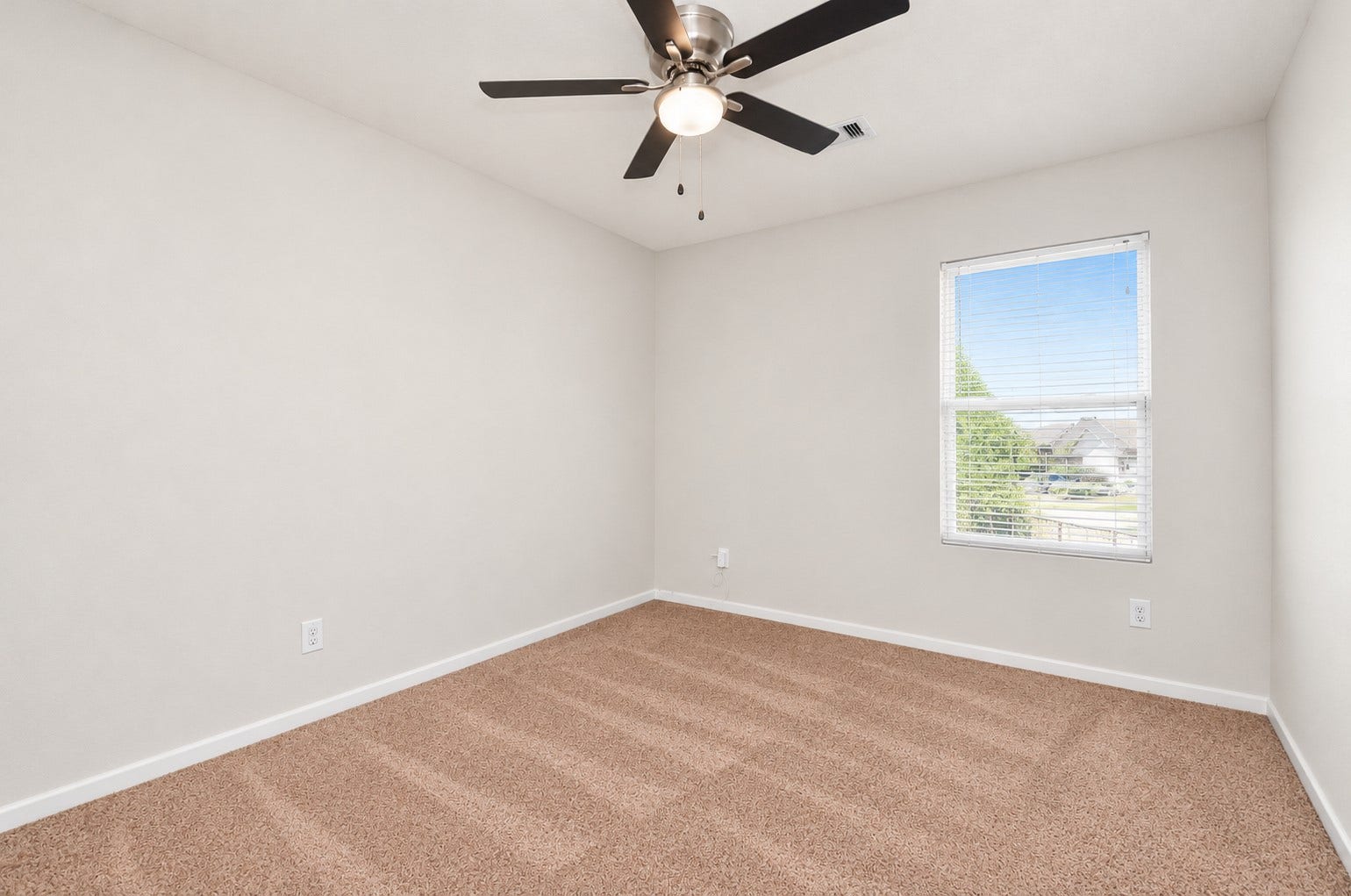 5031 Grove Square Court, Katy, TX 77449 Fourth bedroom upstairs featuring neutral carpeting, a ceiling fan and a window providing natural light.