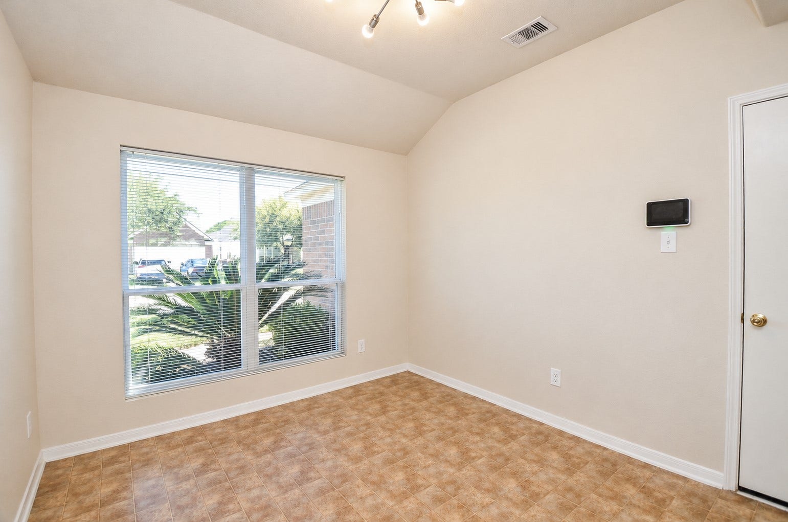 5031 Grove Square Court, Katy, TX 77449 Formal dining room featuring a large window, vaulted ceiling and natural light, ideal for everyday dining or entertaining.