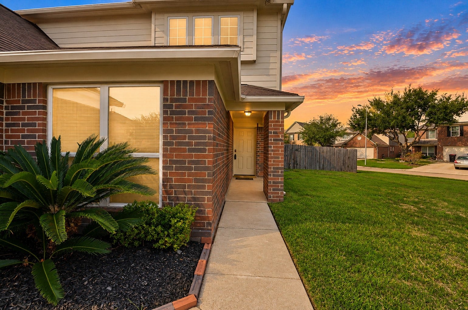 5031 Grove Square Court, Katy, TX 77449 Side view showcasing the home's brick exterior, manicured landscaping and spacious yard.