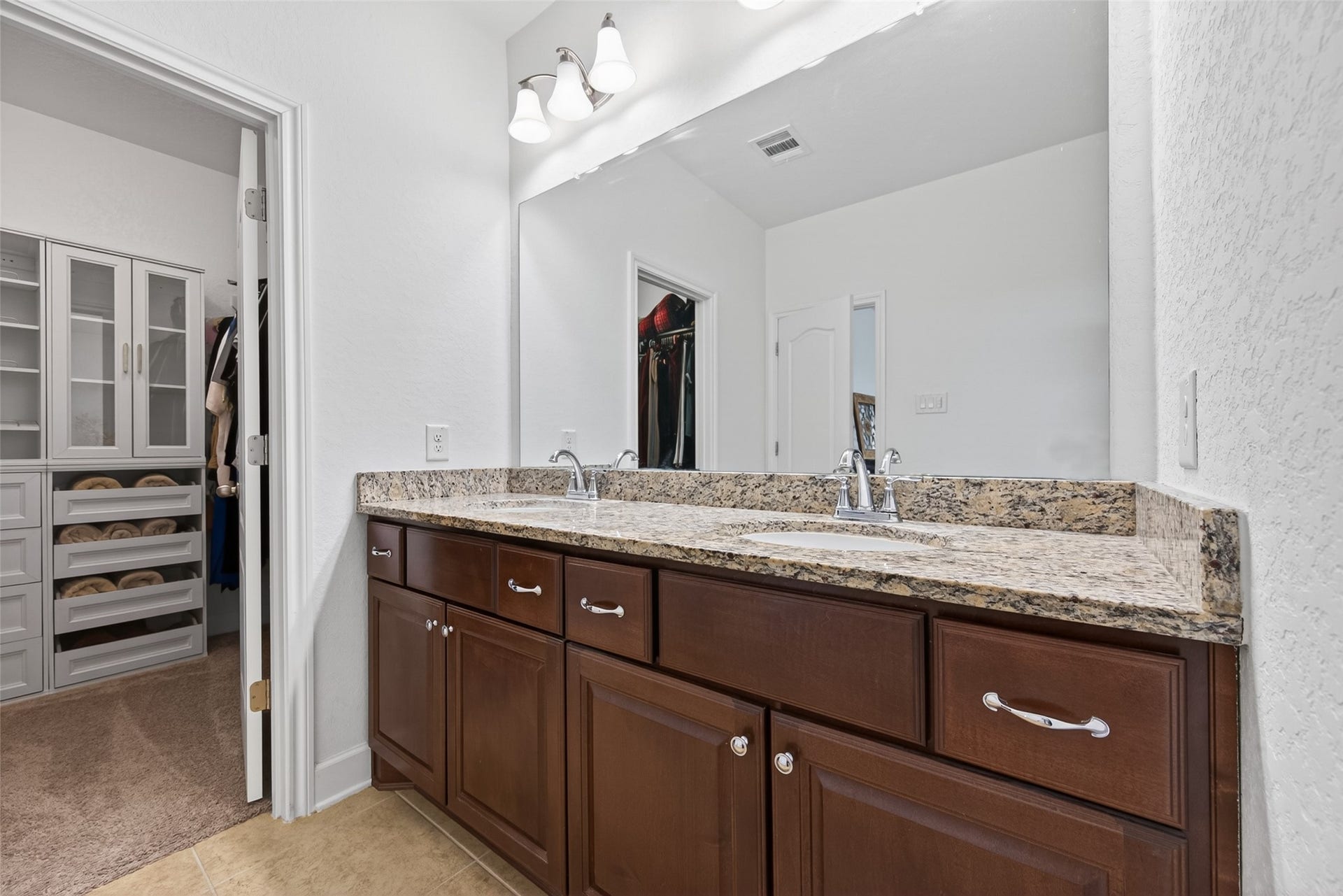Primary bathroom with walk in closet and storage