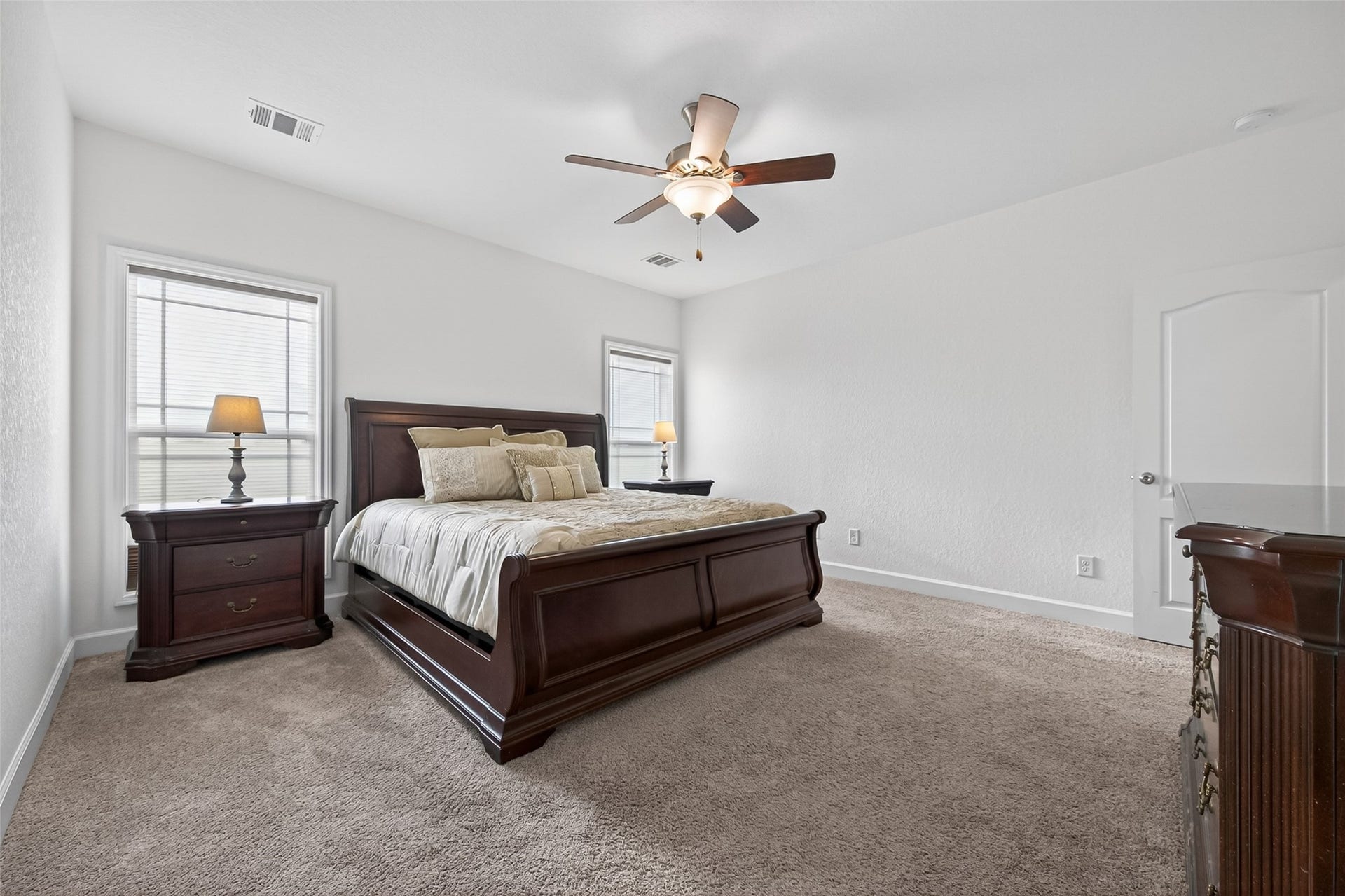Primary Bedroom with ceiling fan and natural light