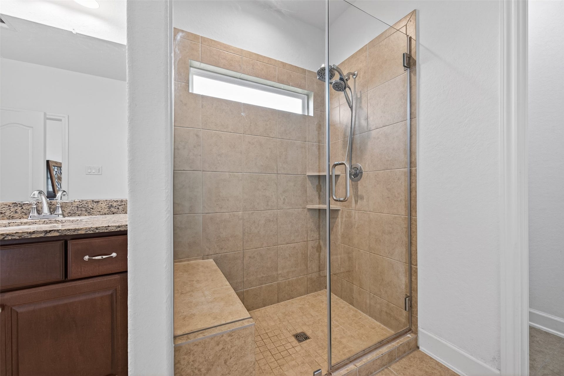 Primary Shower with tile and bench seat