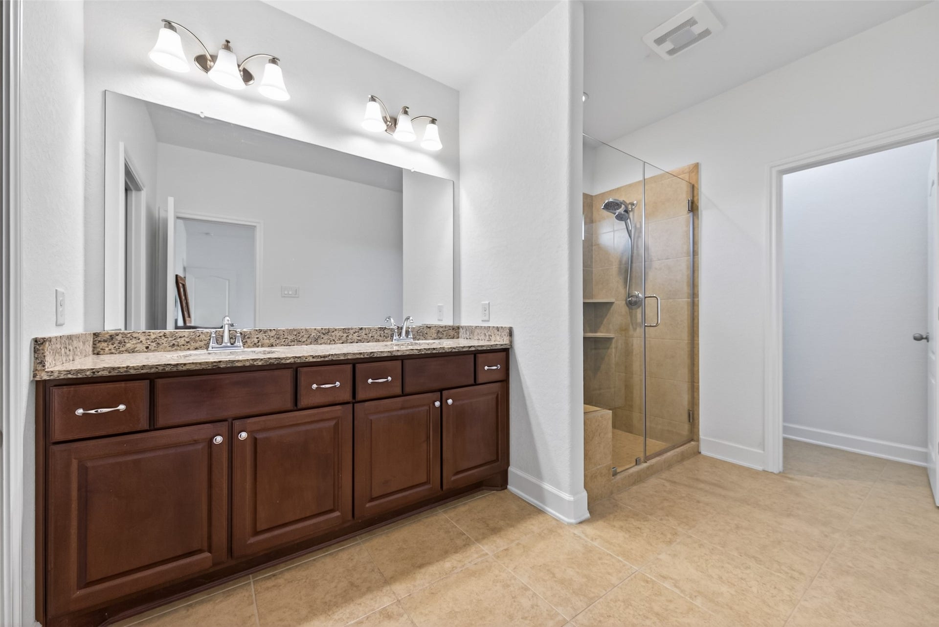 Primary Bathroom with dual sinks & granite countertops