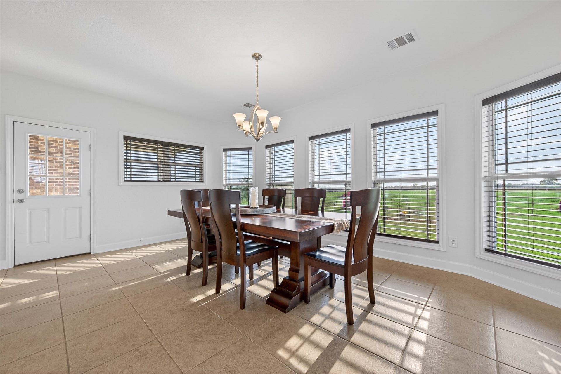 Expansive dining area with abundant natural light and acreage views