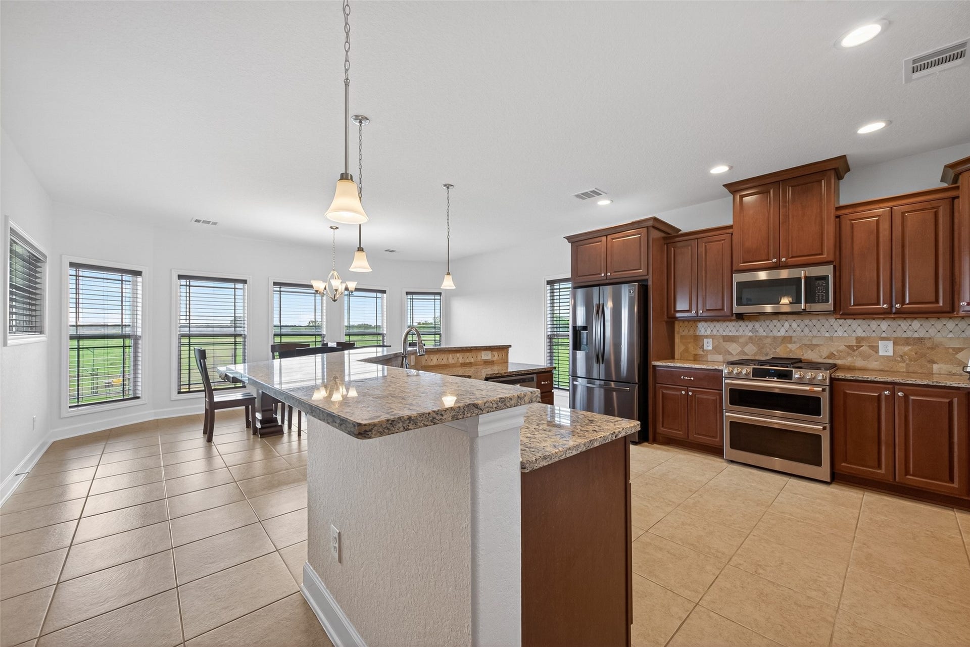 Kitchen with granite counters, Cafe appliances & custom Kent Moore soft close cabinets and drawers with specialty pull out organizers
