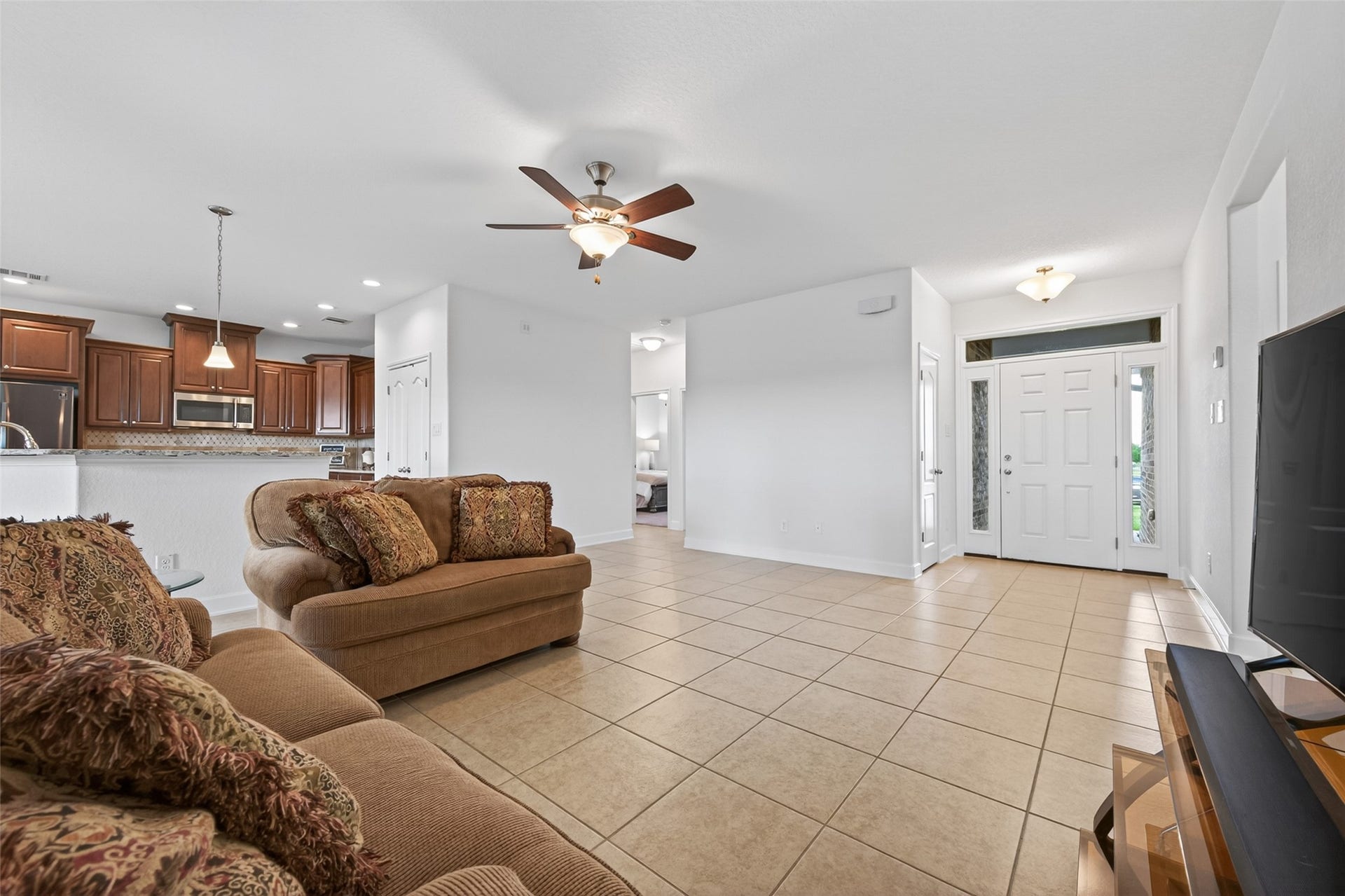Open concept entry and living room area with tile floors