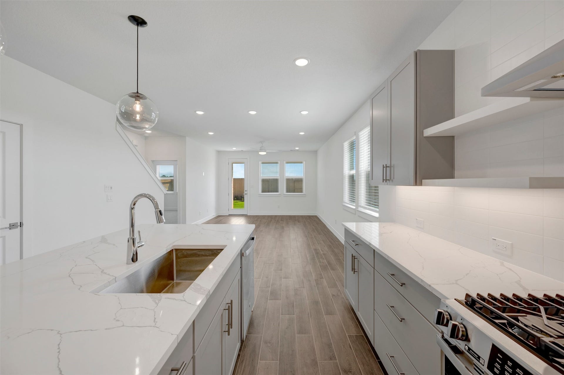 23647 Gulf Prairie Drive, Katy, TX 77493 Stylish kitchen with light grey cabinets and floating shelves