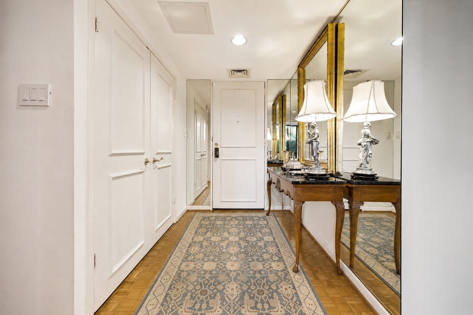 Interior front foyer with a mirrored entry, reflecting light and adding instant charm. Directly opposit of it is a double door leading to a large storage room and cedar closet