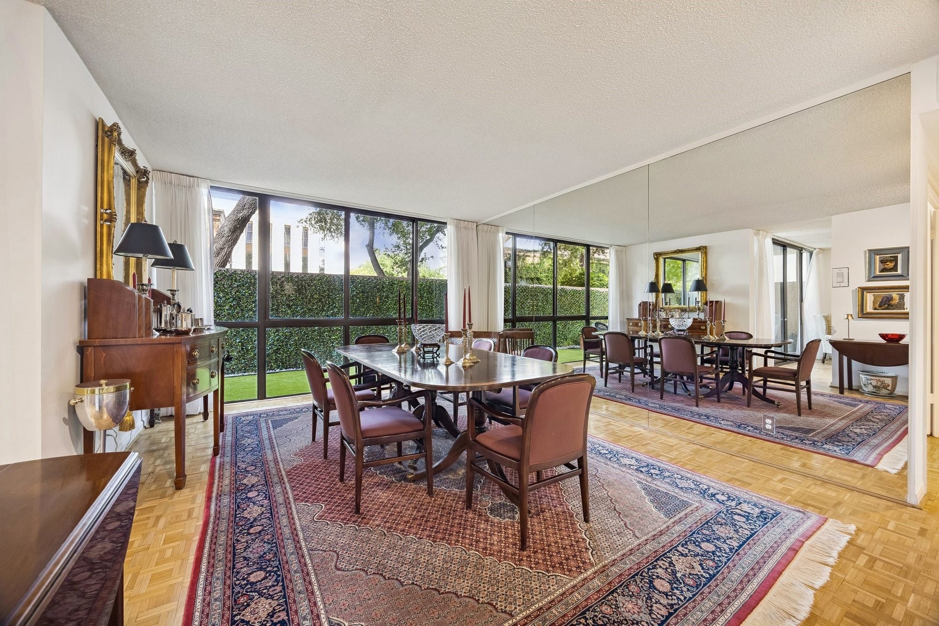 A mirrored reflection view of the formal dining room displaying the beautiful Parquetry hardwood floors throughout.