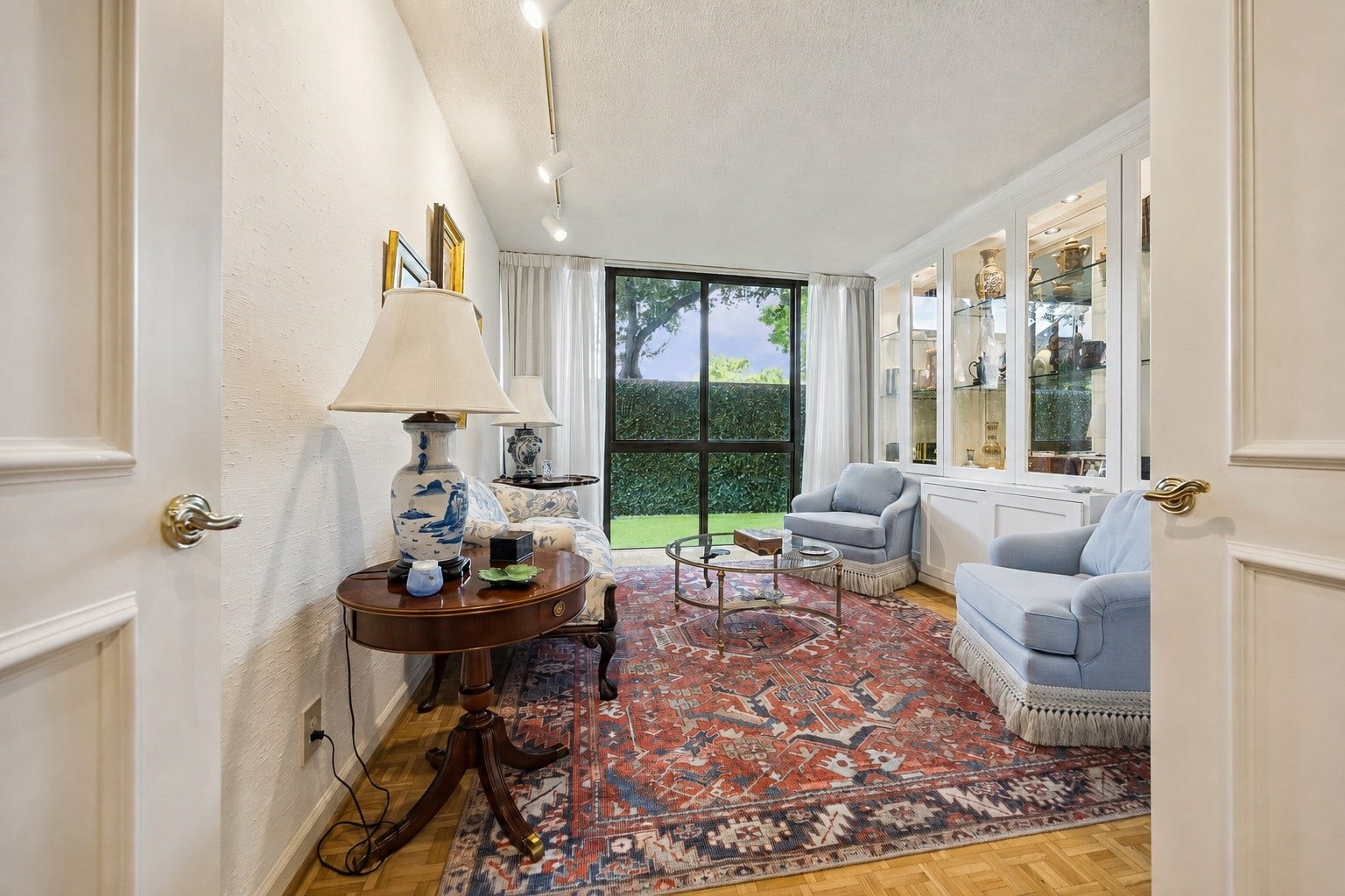 Alternate view of the secondary guest bedroom, (currently used as additional living space) offering double-door entry and scenic back yard views.