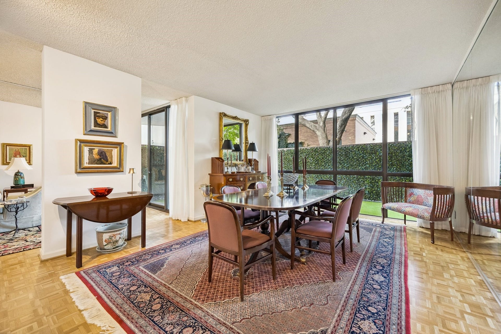 Light-filled formal dining room with walls of windows designed to capture the private outdoor terrace views.