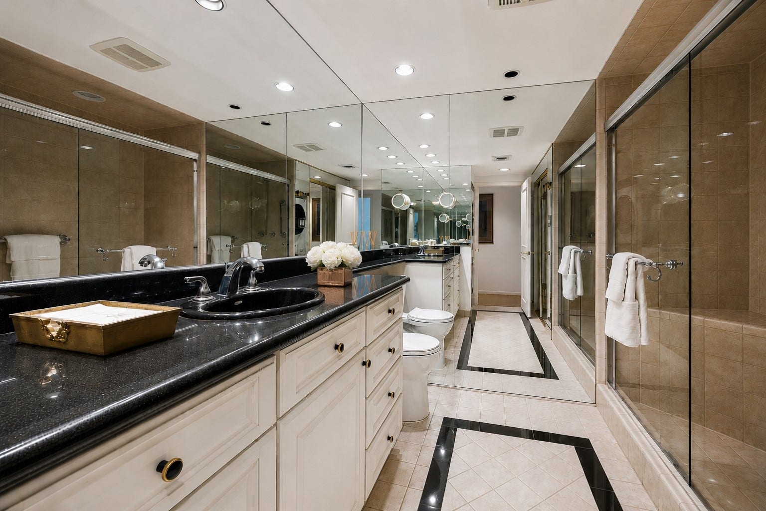 Secondary guest bathroom complete with frameless glass enclosed walk-in shower, custom designer vanity and framed glass mirror
