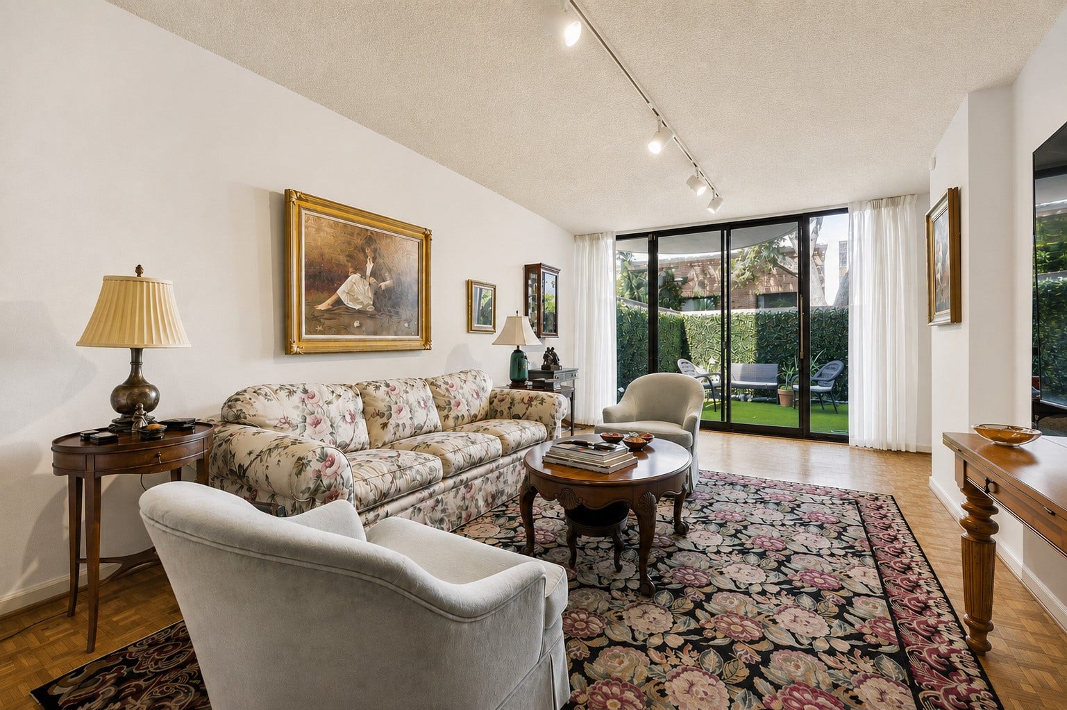 Quiet and serene. This family room is a peaceful haven, perfect for relaxing after a long day.  Double glass sliding doors capture a clear view of the private outdoor terrace.