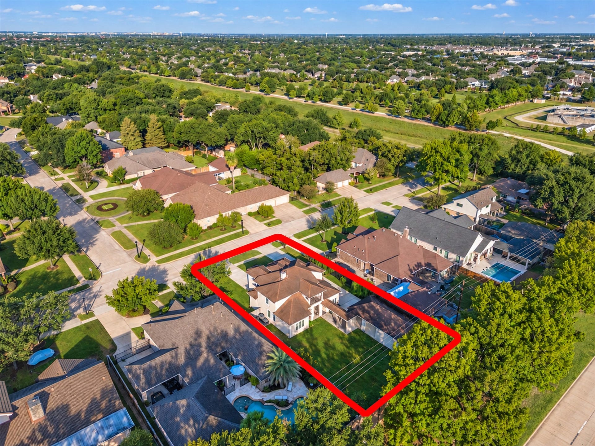 8606 Argentina Street, Houston, TX 77040 Aerial view showcasing the homes distinctive architecture, spacious lot, detached garage, and generous driveway parking.