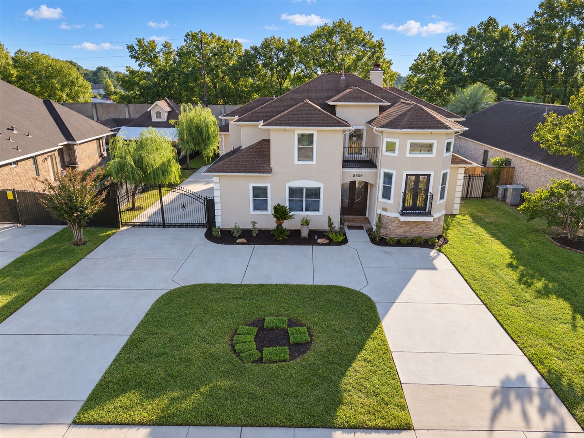 8606 Argentina Street, Houston, TX 77040 Gated Driveway: An ornamental iron gate adds a distinctive finishing touch to the driveway entrance.