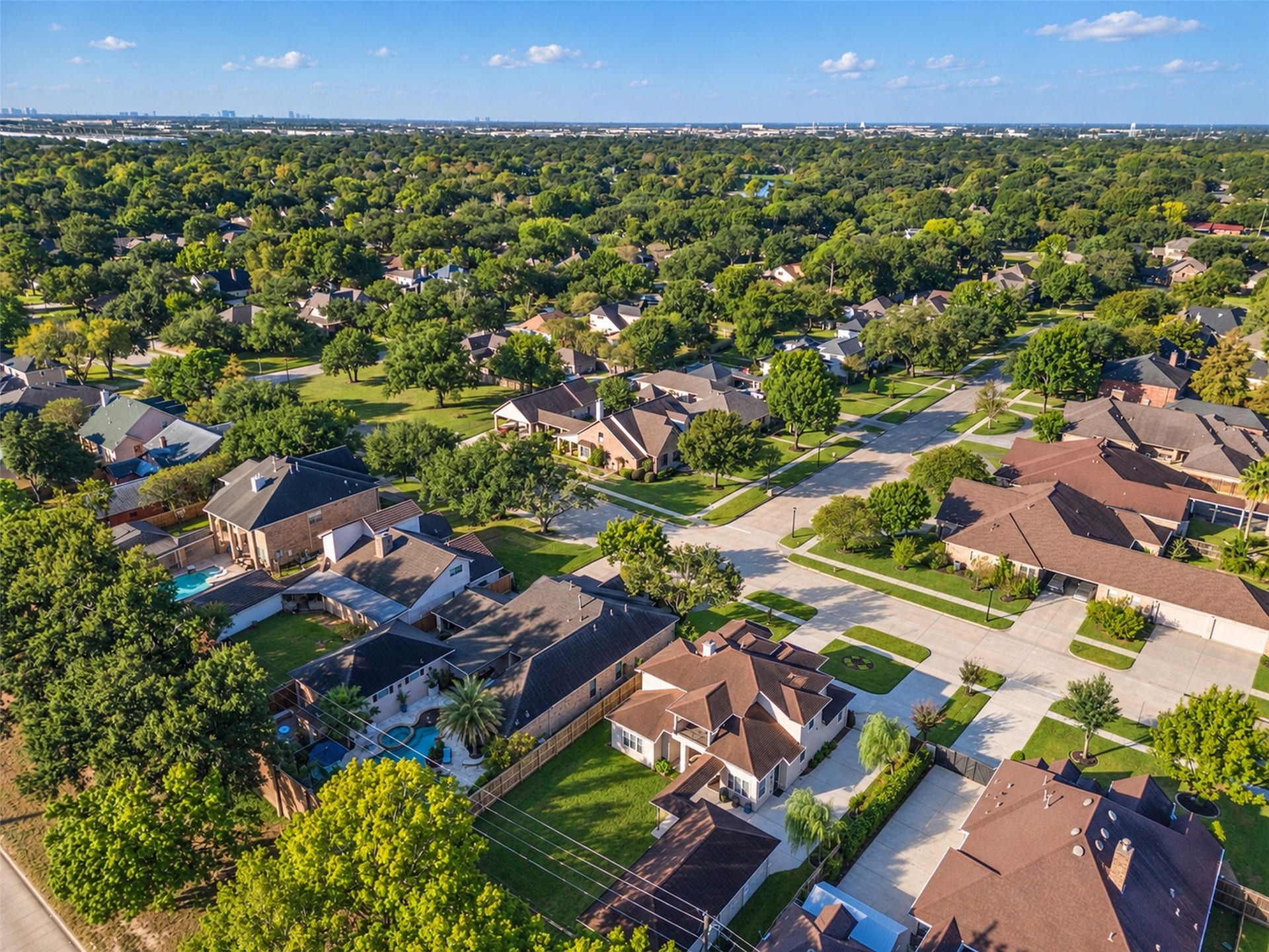 8606 Argentina Street, Houston, TX 77040 Aerial view showcasing the homes distinctive architecture, spacious lot, detached garage, and generous driveway parking.