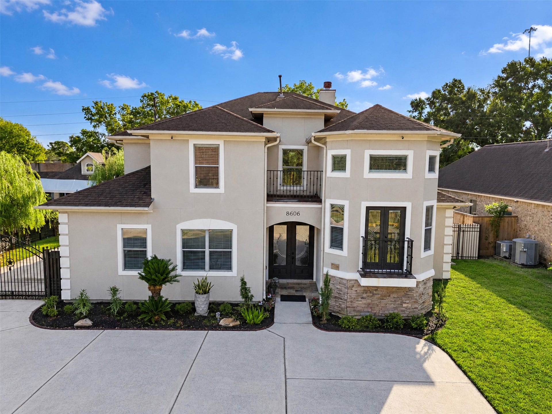 8606 Argentina Street, Houston, TX 77040 Distinctive two-story architecture with a sophisticated stucco exterior and contrasting stone accents.