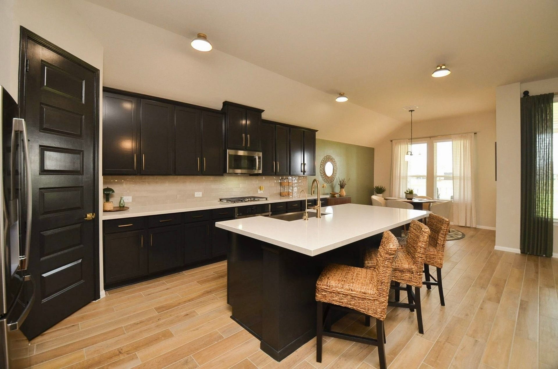 6803 Nichols Landing, Needville, TX 77461 Wood-look tile, spacious pantry, under cabinet lighting and beautiful cabinet hardware