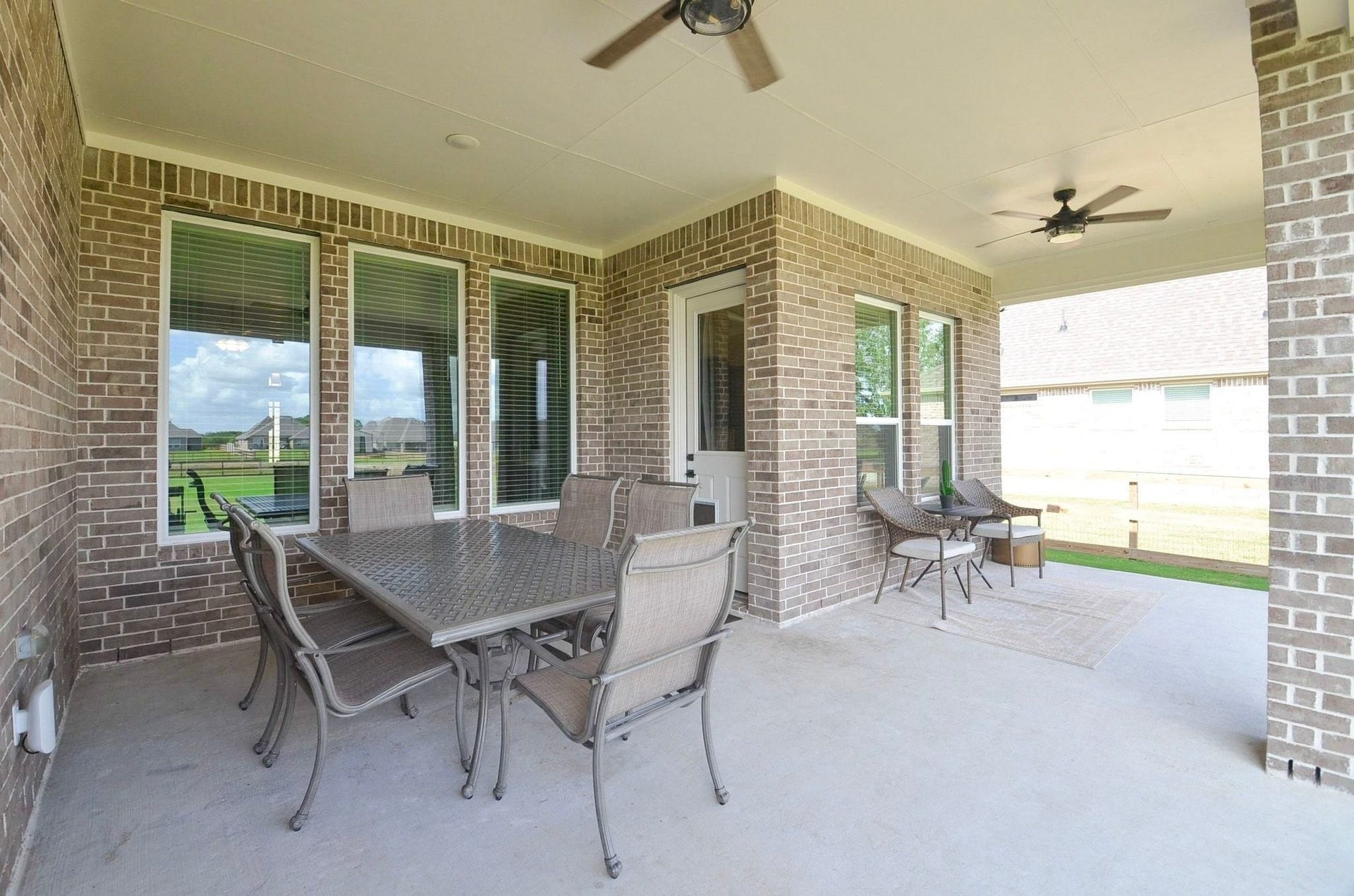 6803 Nichols Landing, Needville, TX 77461 Extended covered patio with two ceiling fans- a great spot to relax after a long day!