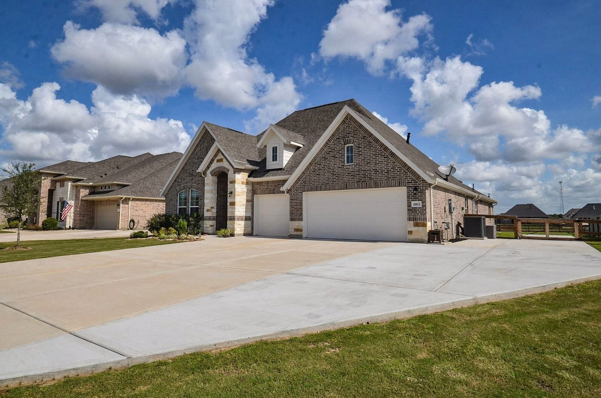 6803 Nichols Landing, Needville, TX 77461 THREE car garage, EXTRA WIDE driveway- plenty of parking and the owners extended the drive around the side of the house