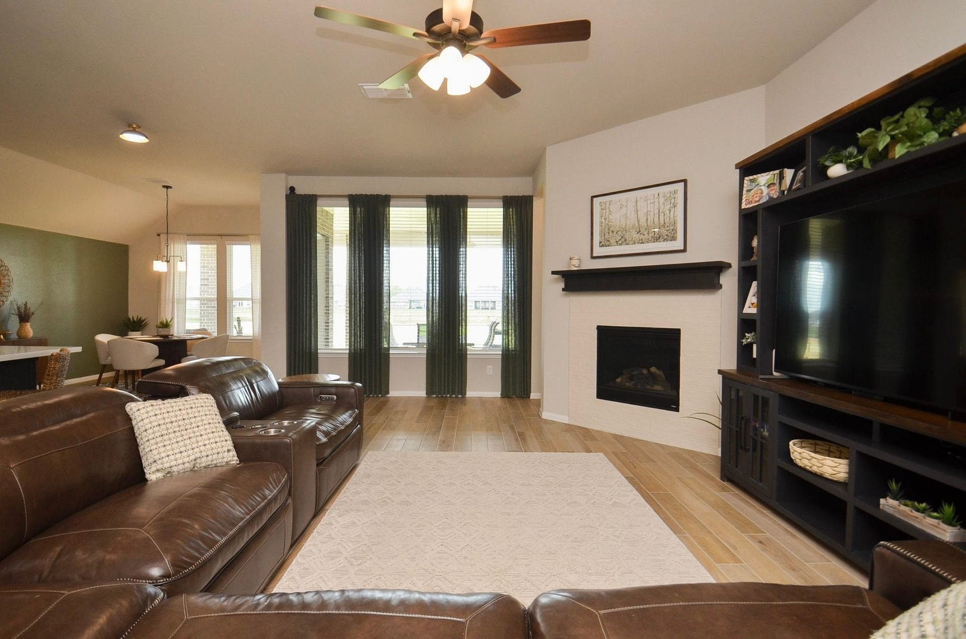 6803 Nichols Landing, Needville, TX 77461 Spacious family room with beautiful fireplace & mantle and lots of natural light