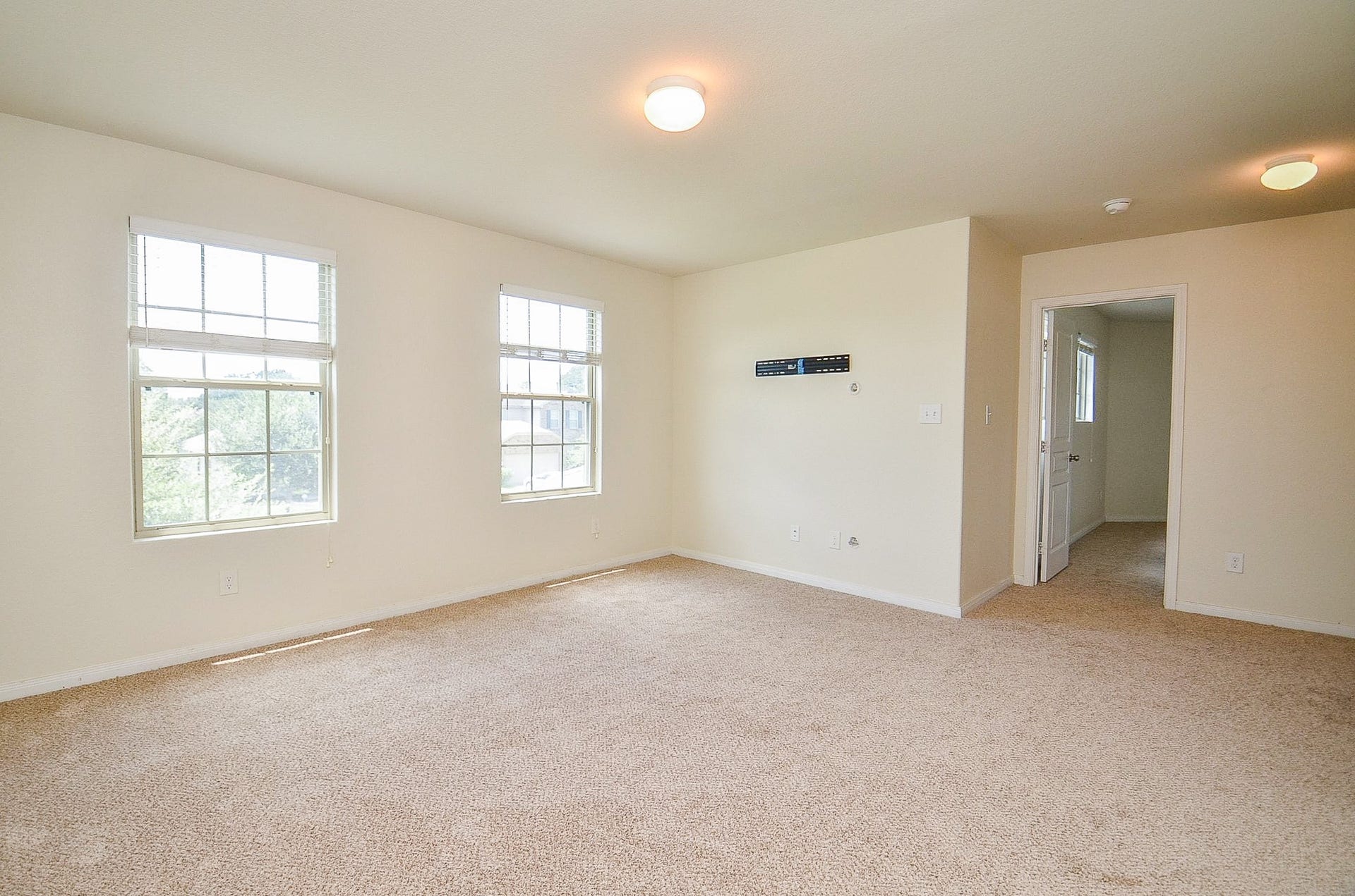 2539 Bedrock Lane, Missouri City, TX 77489 Spacious room with soft carpet, large windows for natural light, and neutral walls, perfect for versatile decorating options.