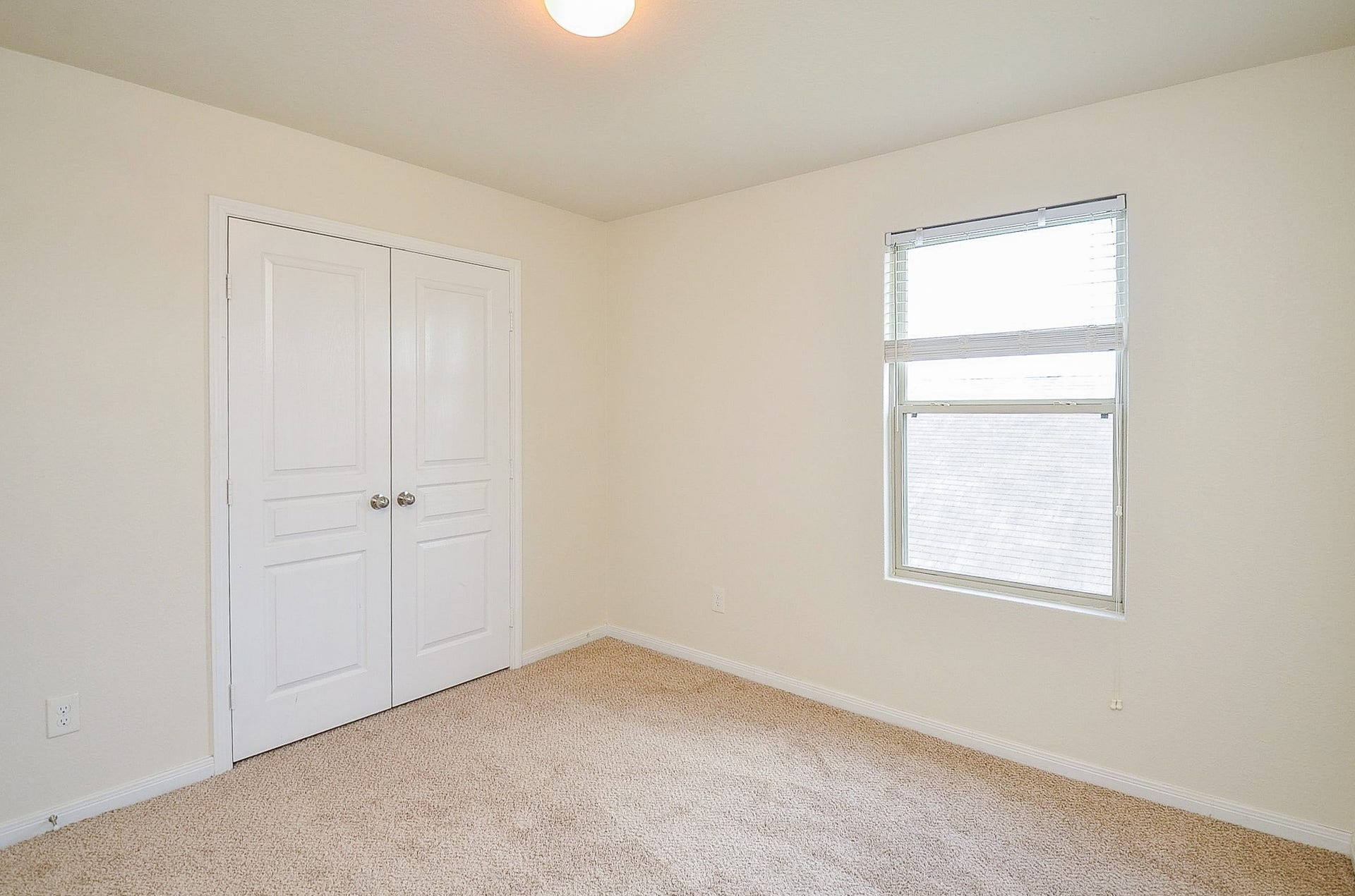 2539 Bedrock Lane, Missouri City, TX 77489 Bright and airy bedroom featuring plush carpeting, a large window for natural light, and ample closet space with double doors.
