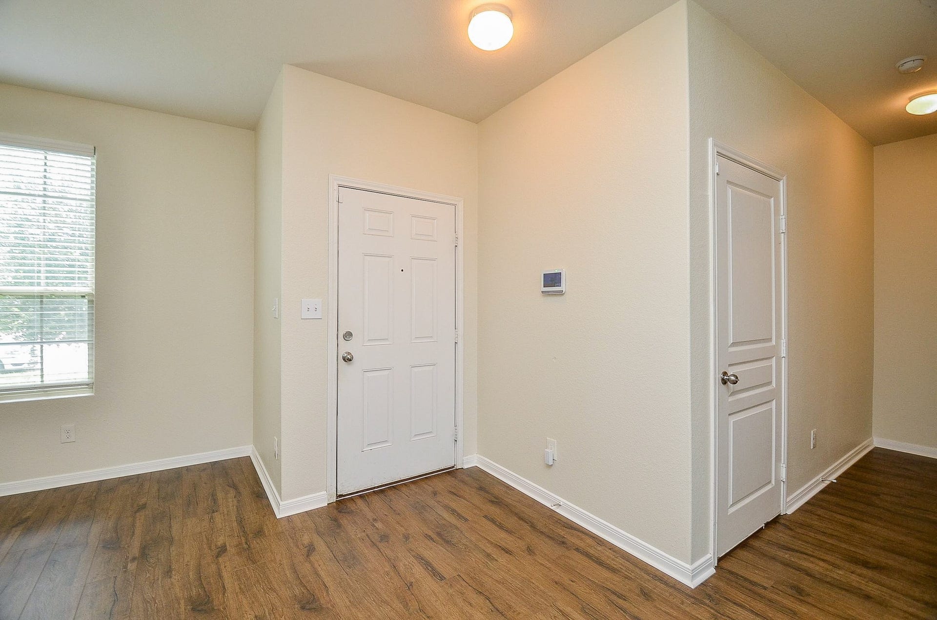2539 Bedrock Lane, Missouri City, TX 77489 Inviting entryway featuring warm wood flooring, neutral walls, and ample natural light, creating a welcoming atmosphere.