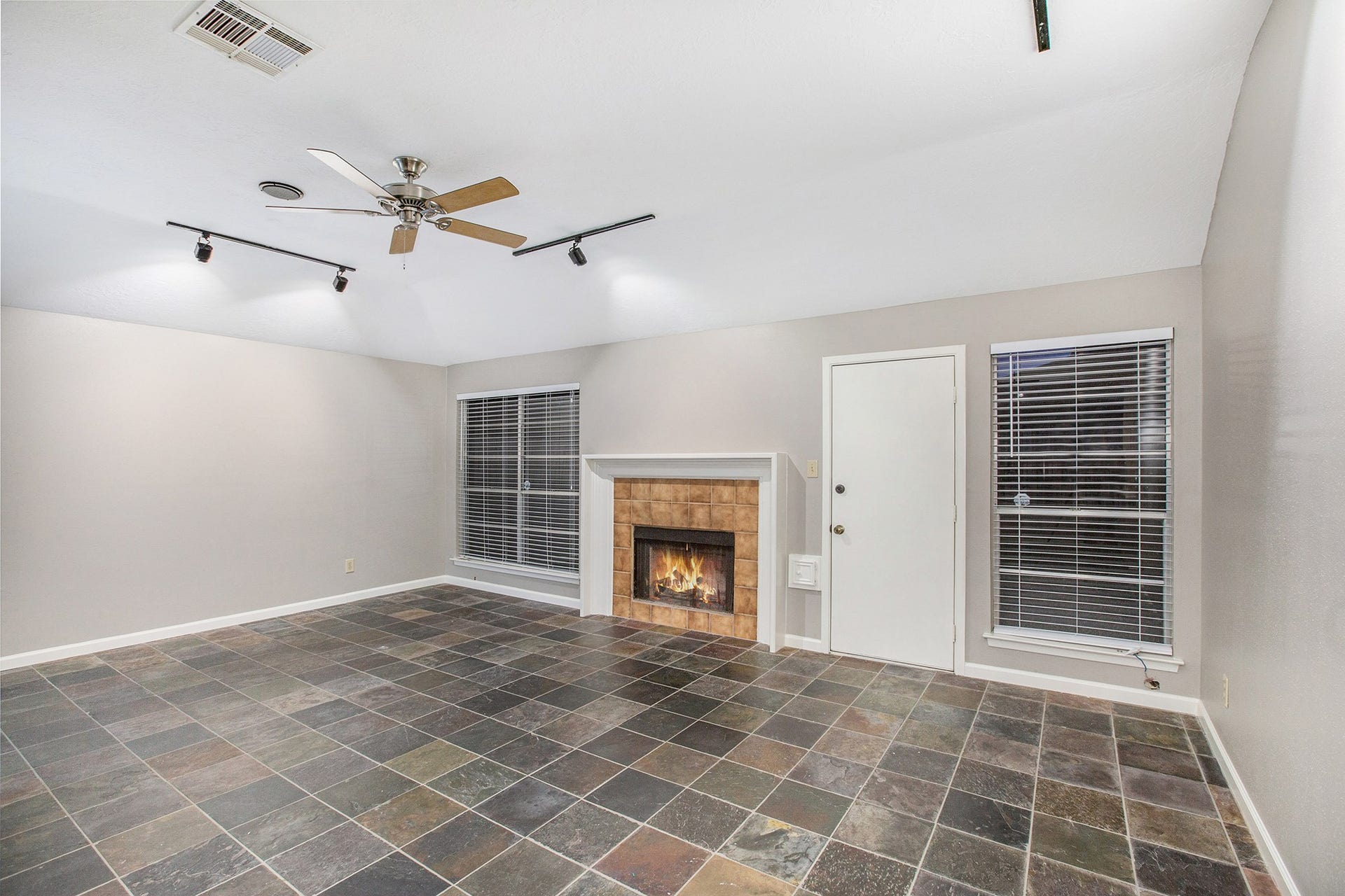 17002 Sky Blue Place, Houston, TX 77095 Large family room features stunning slate floor, track lighting, gaslog fireplace with tile surround and direct access to the backyard.