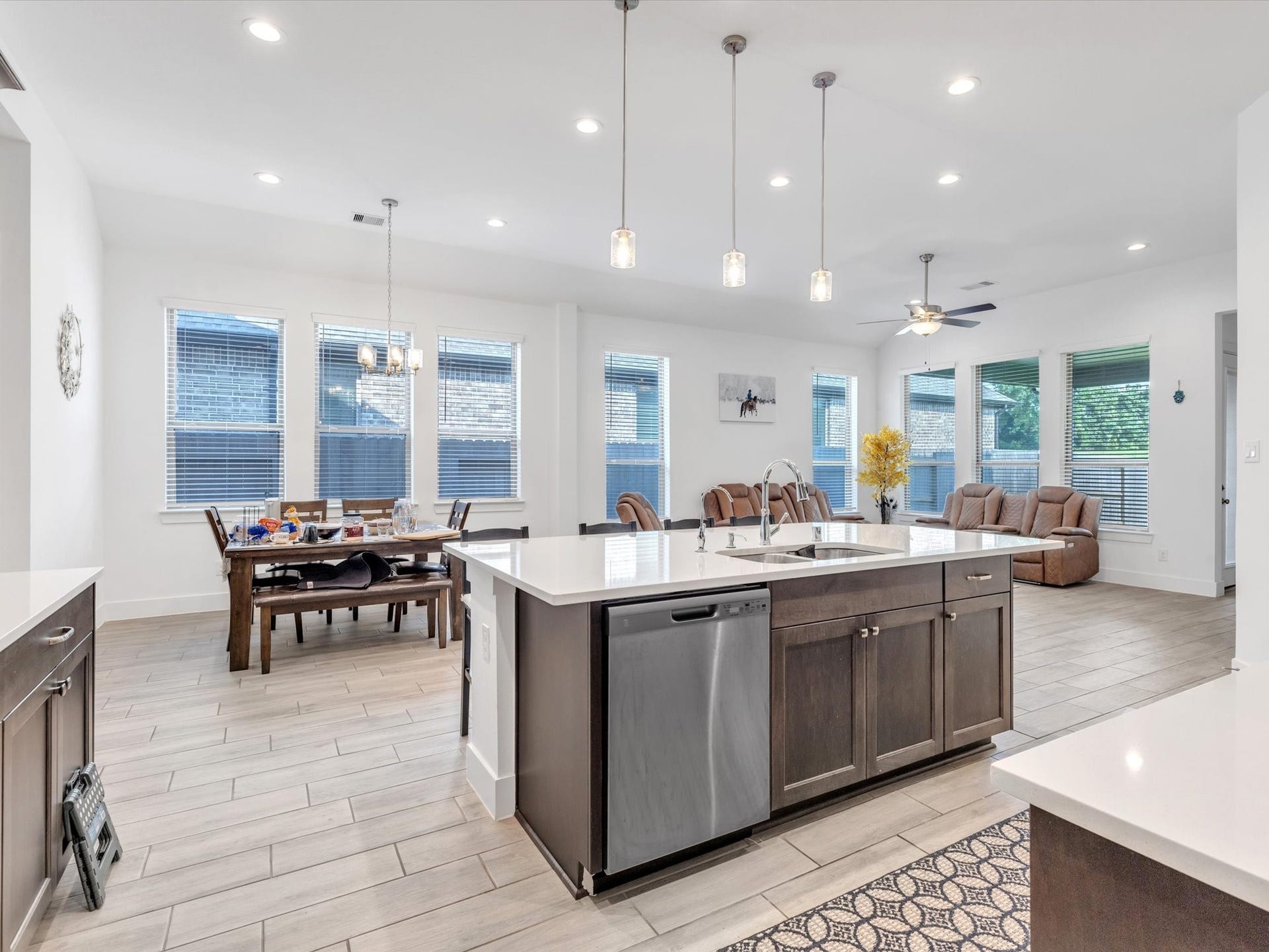 10718 Hidden Rock Drive, Missouri City, TX 77459 At the center of the home, the oversized kitchen island provides exceptional prep space, additional storage and a natural gathering place overlooking the dining and family rooms.