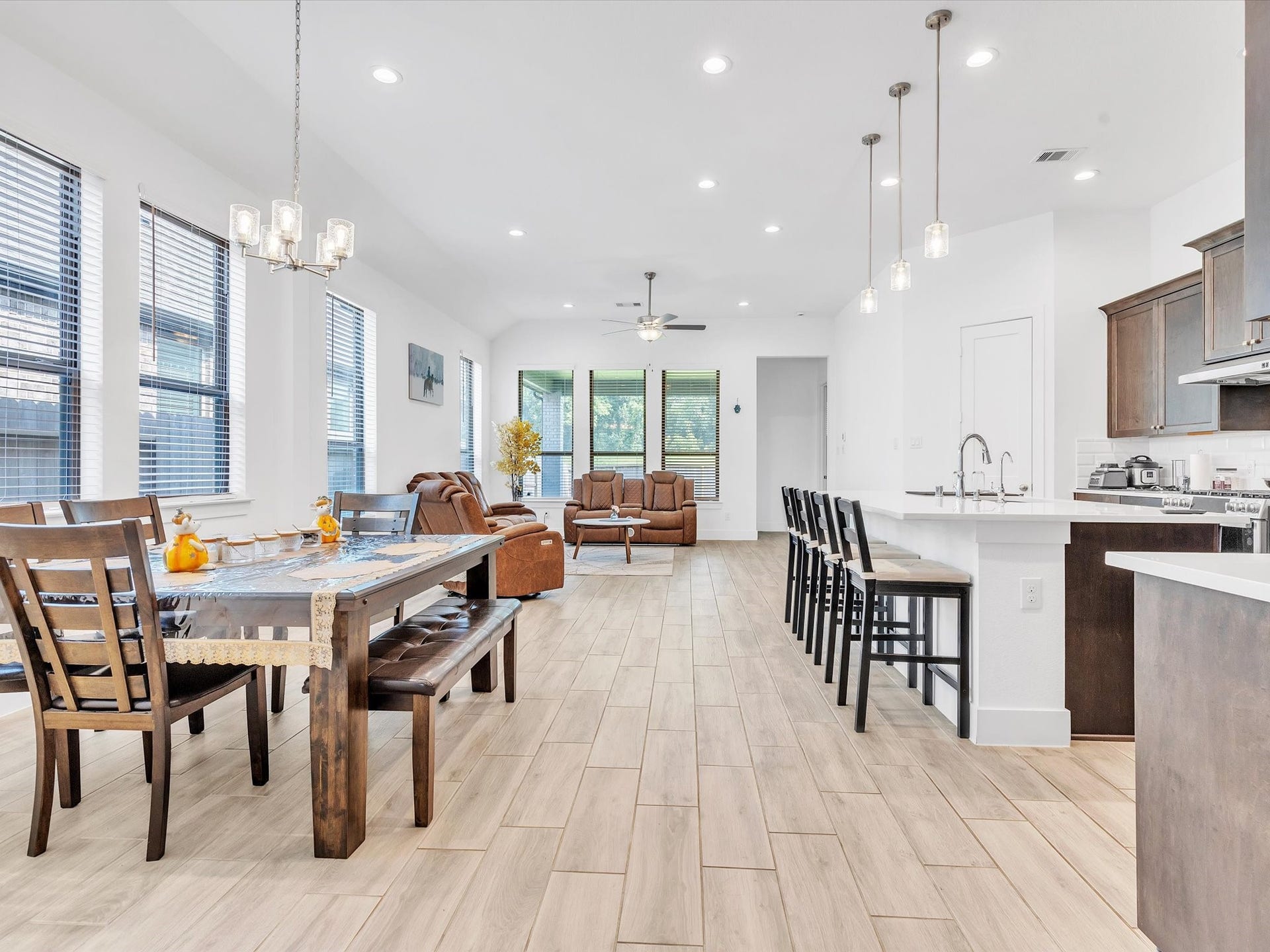 10718 Hidden Rock Drive, Missouri City, TX 77459 Designed for everyday living and entertaining, the open-concept layout seamlessly connects the kitchen, dining and family areas while expansive windows fill the space with natural light.