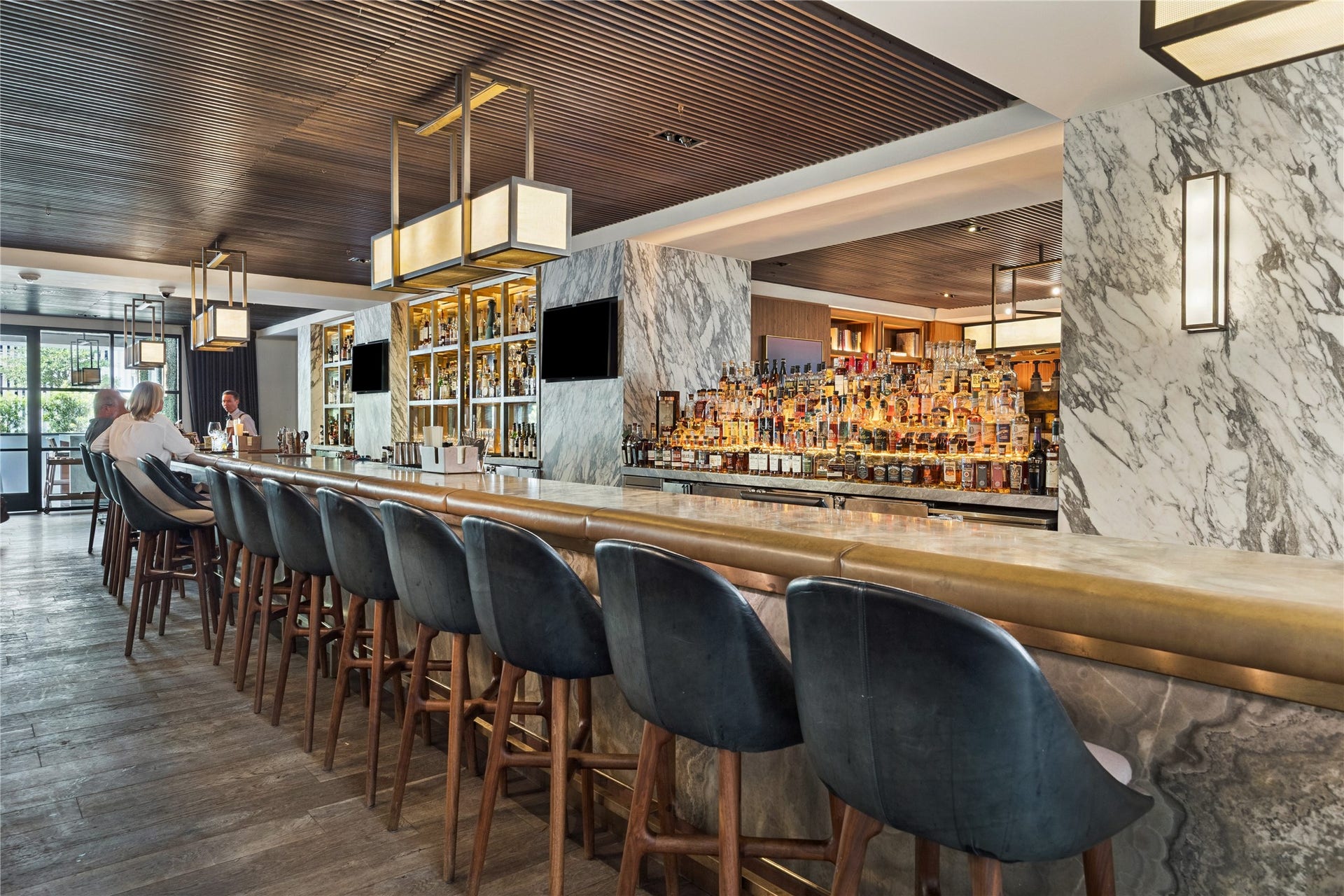 1111 Caroline Street, #2606, Houston, TX 77010 Located just beyond Bayou & Bean, this inviting bar features marble accents, warm wood finishes, and an impressive selection of spirits. It offers a stylish setting for cocktails, casual meetings, or unwinding at the end of the day.