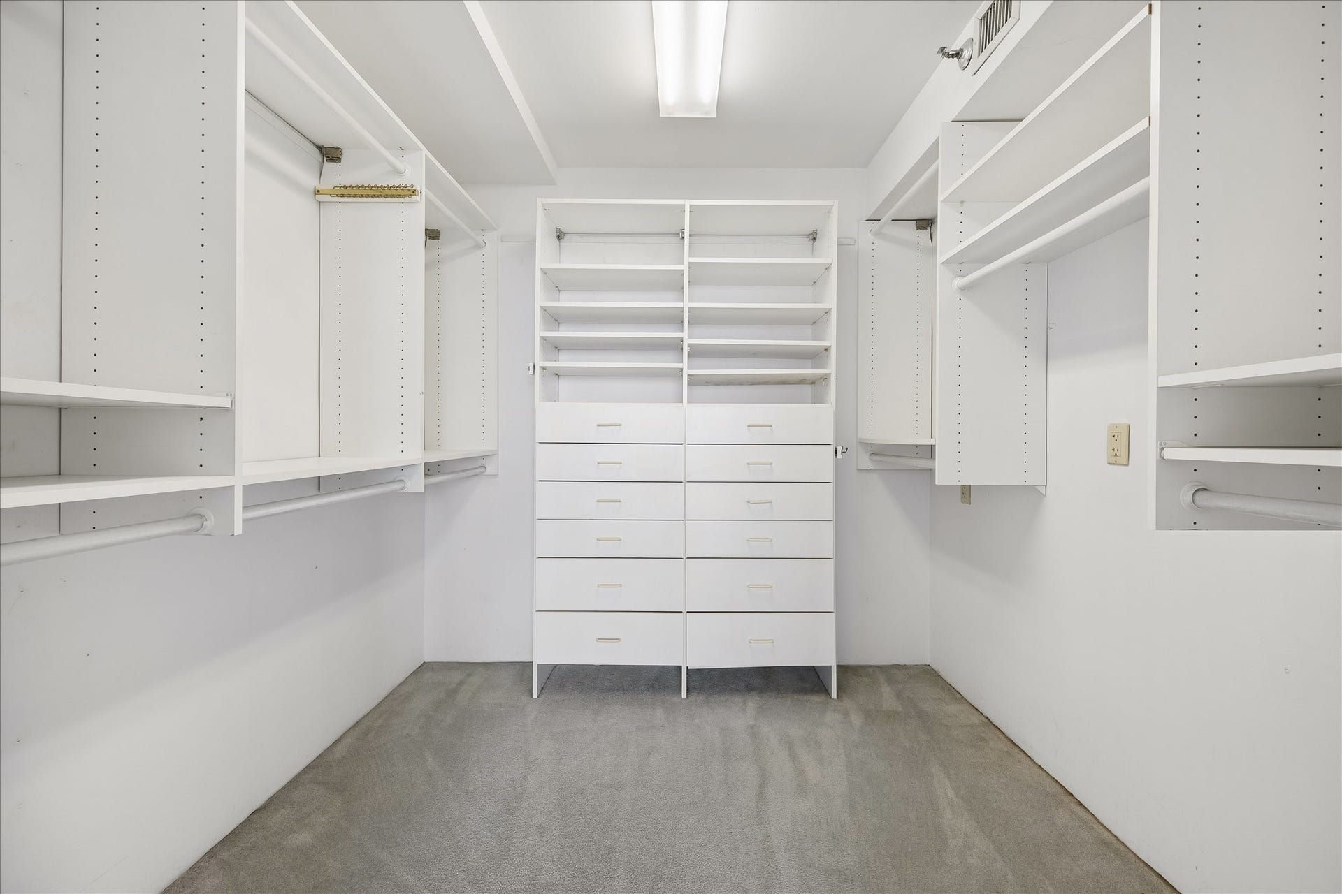 1111 Caroline Street, #2606, Houston, TX 77010 Hanging rods, open shelving and a central bank of drawers bring structure to the walk in closet. Dedicated areas for clothing, shoes and accessories make it easy to organize daily essentials.