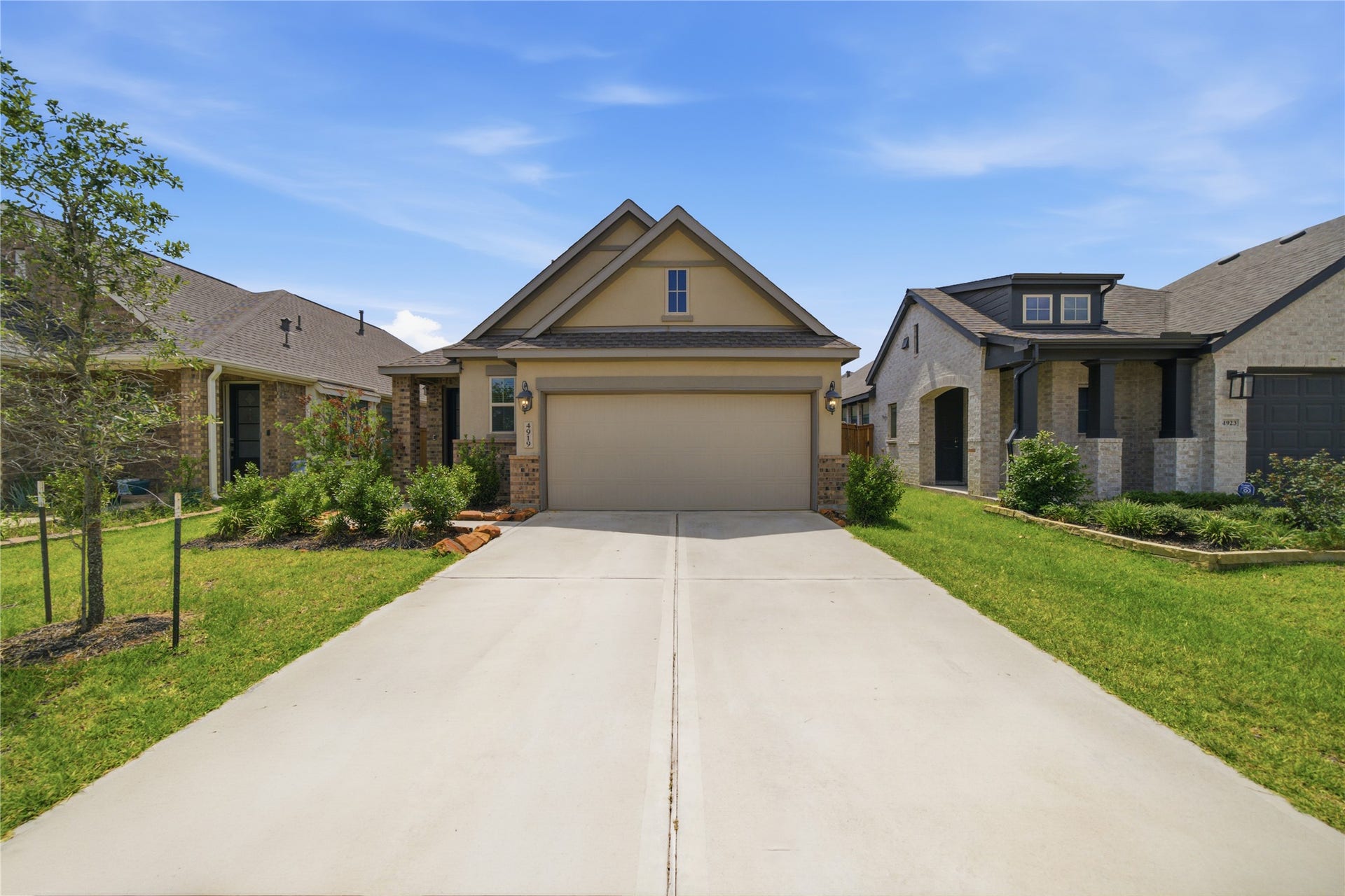 4919 Sand Clouds Drive, Katy, TX 77493 A spacious double driveway leading to a two-car garage allowing for plenty of parking space The garage has an EV charging plug installed.