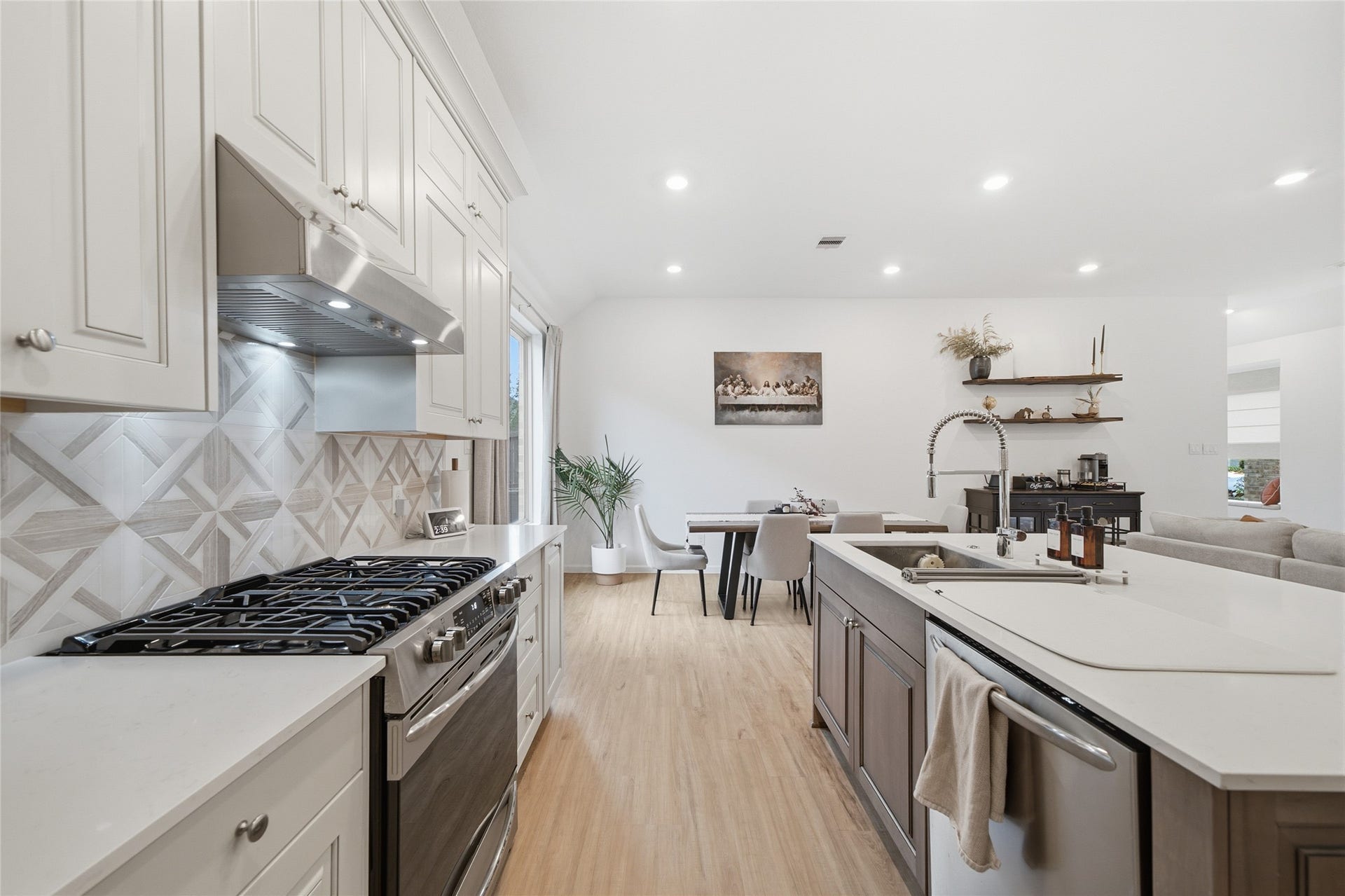 4919 Sand Clouds Drive, Katy, TX 77493 A gas stove with 5 burners and a matching stainless steel exhaust hood