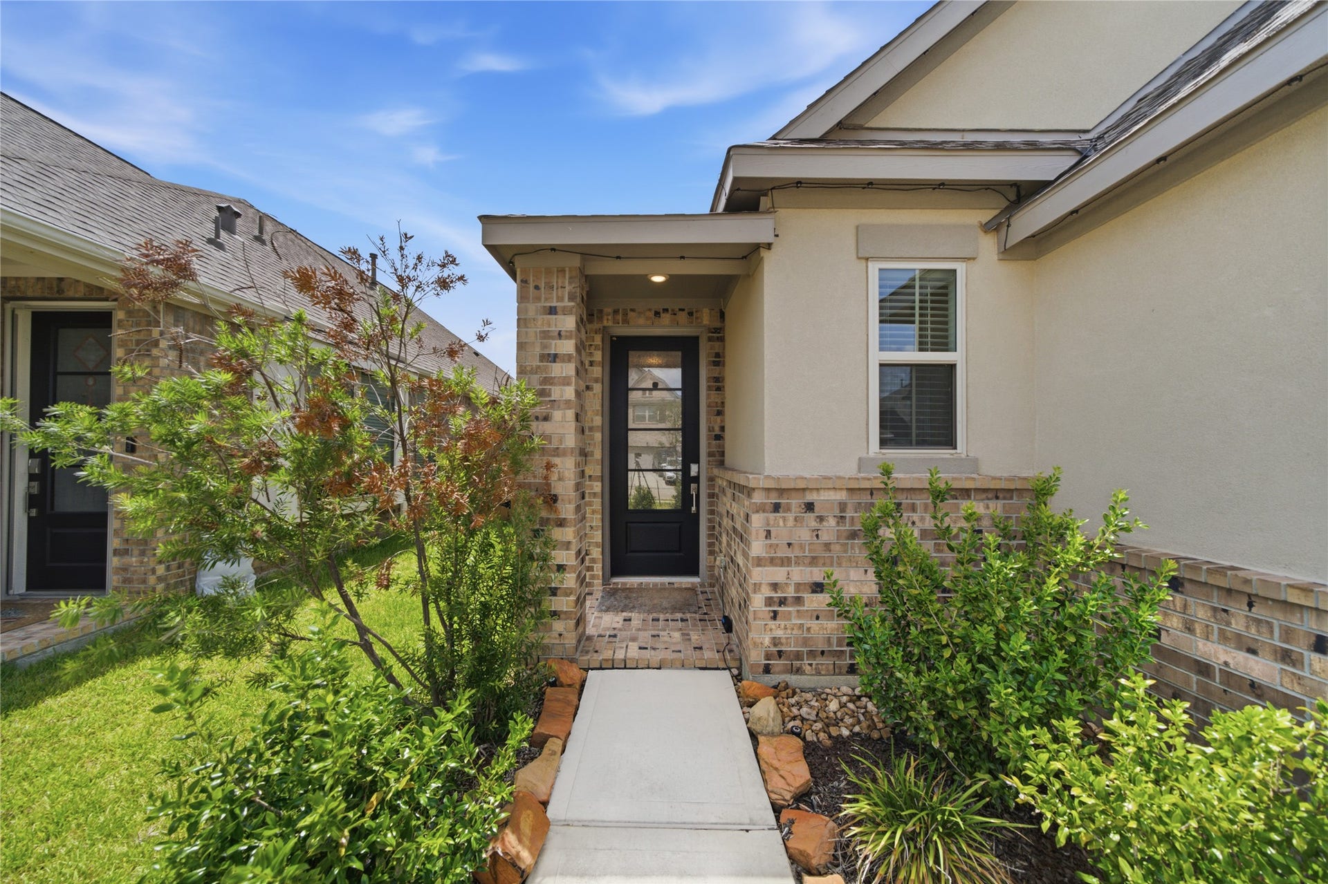 4919 Sand Clouds Drive, Katy, TX 77493 Charming entryway with a brick facade welcomes you to the front door