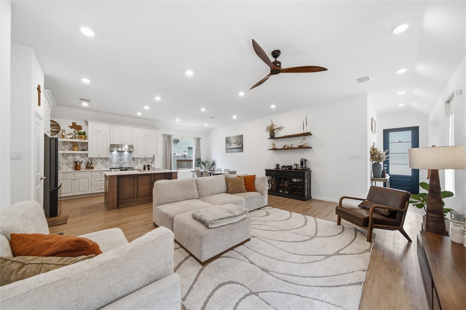 4919 Sand Clouds Drive, Katy, TX 77493 The open-concept living area featuring an adjacent modern kitchen with a large island with cozy seating space.