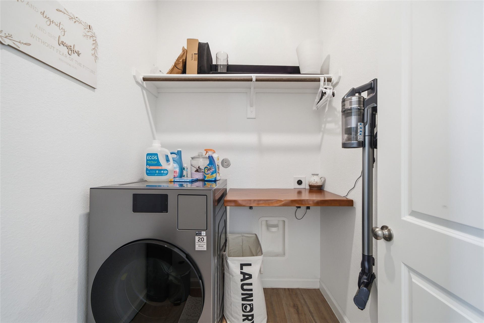 4919 Sand Clouds Drive, Katy, TX 77493 Utility room with built in shelving a hanging rod. The dryer connection is electric.