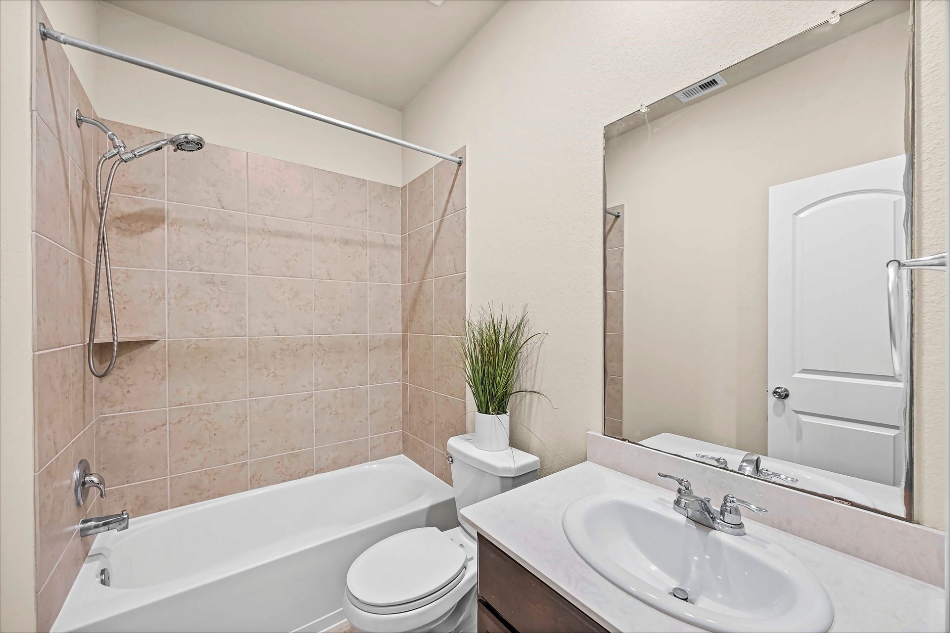 A welcoming secondary bath with a vanity and tub/shower combination makes daily routines easy.