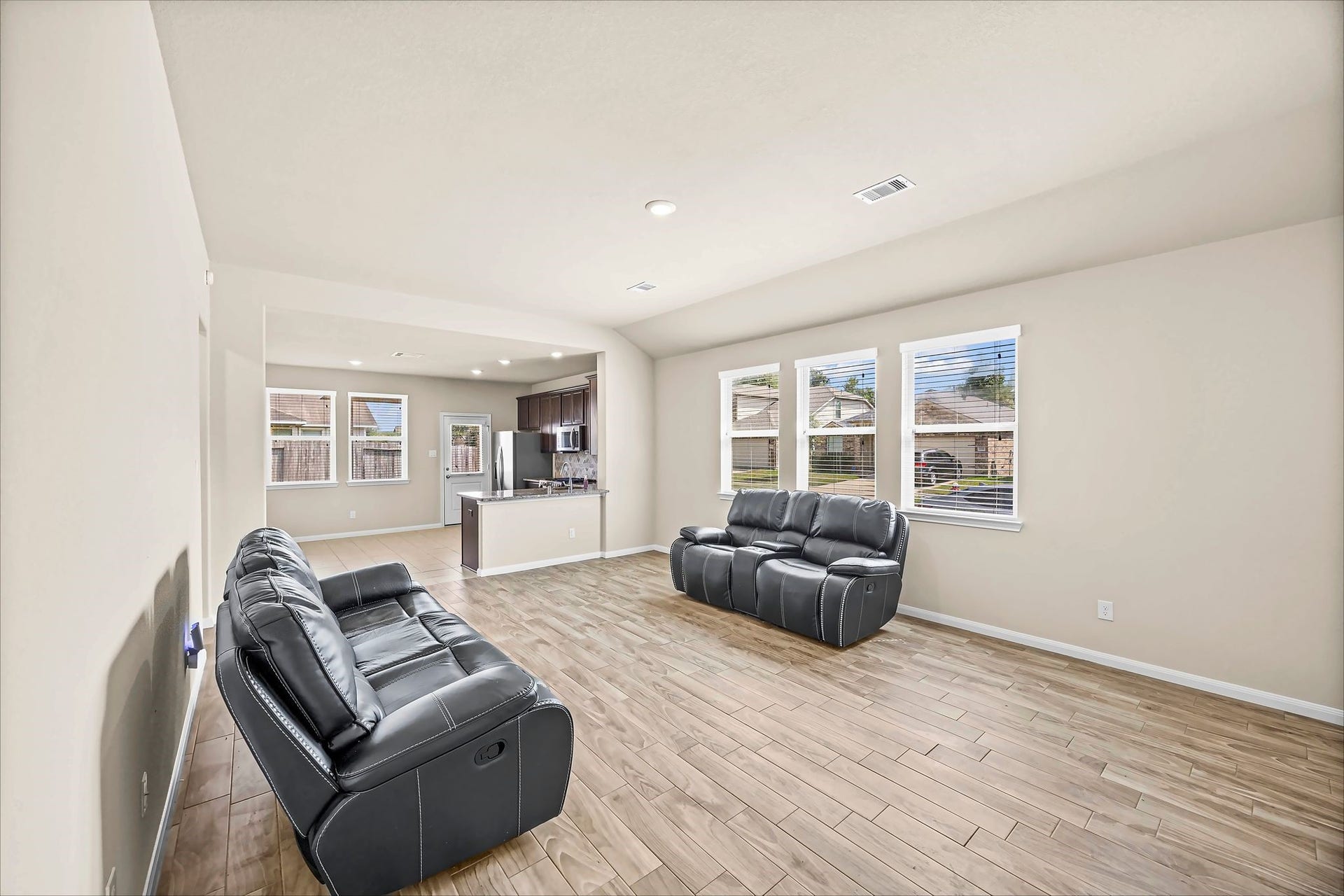 An easy-flowing living space keeps conversation connected from the sofa to the dining area and kitchen.