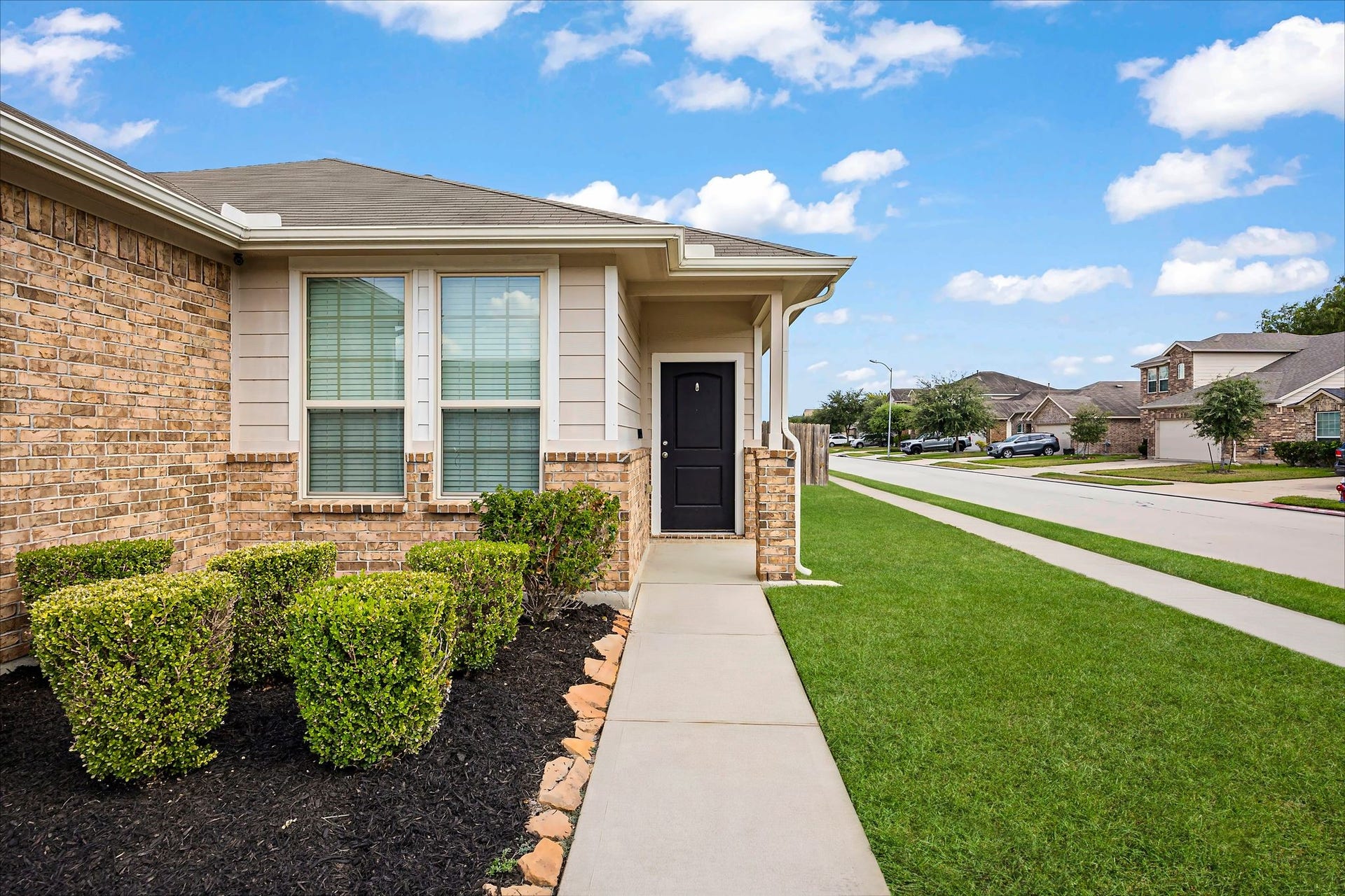 Follow the landscaped walkway to a cozy covered entry and step into your next chapter.