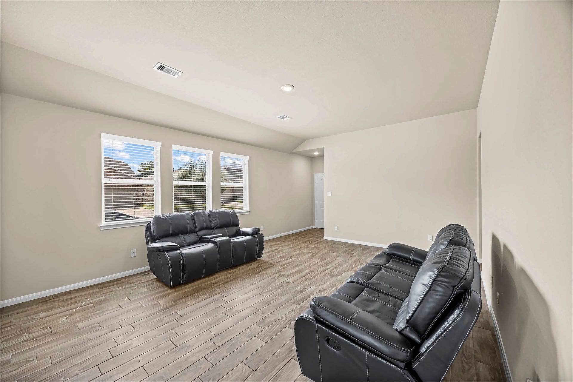 Natural light fills this inviting living room, creating a cheerful spot to unwind and get comfortable.