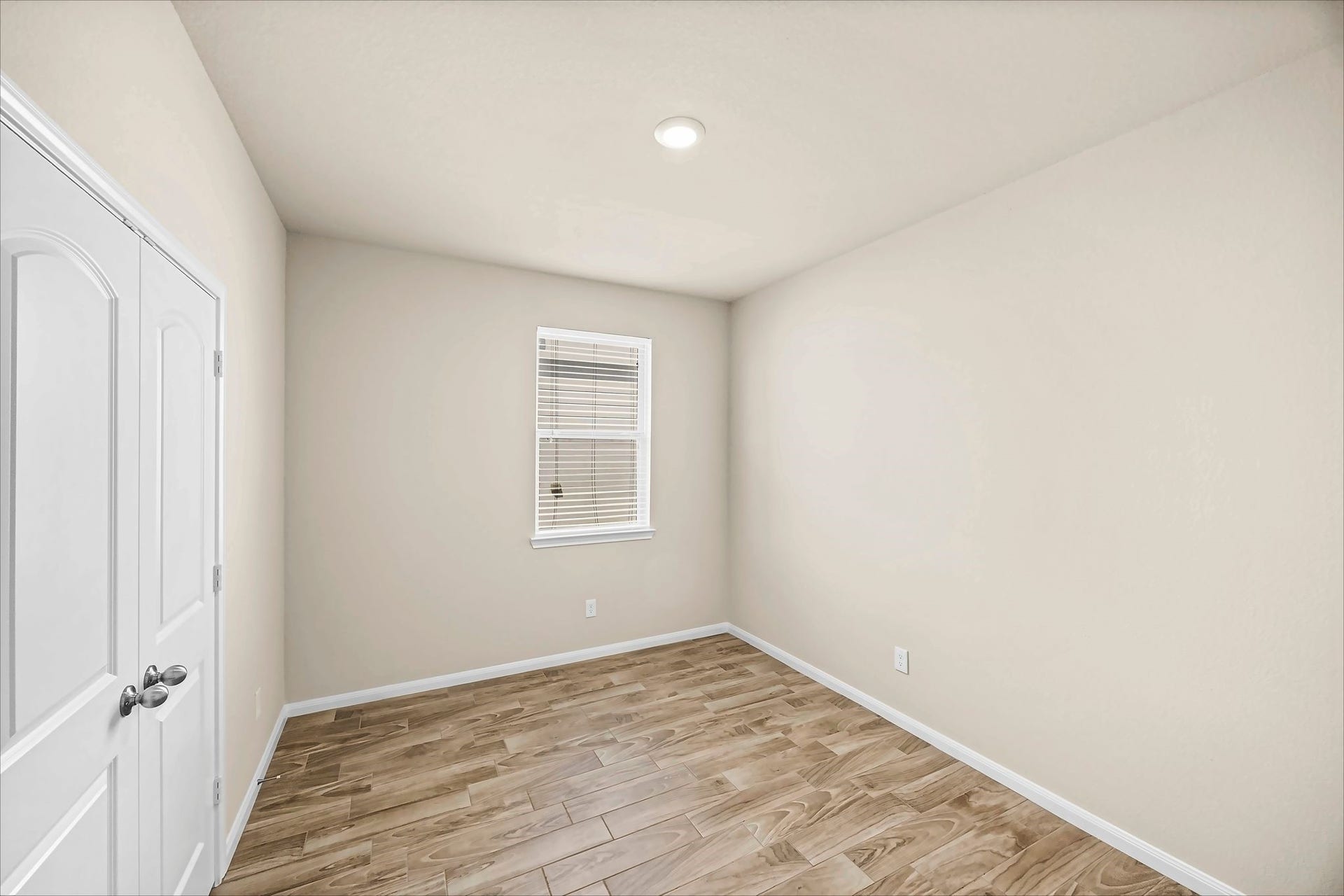 This additional bedroom pairs tile flooring with closet space for a cozy and practical retreat.