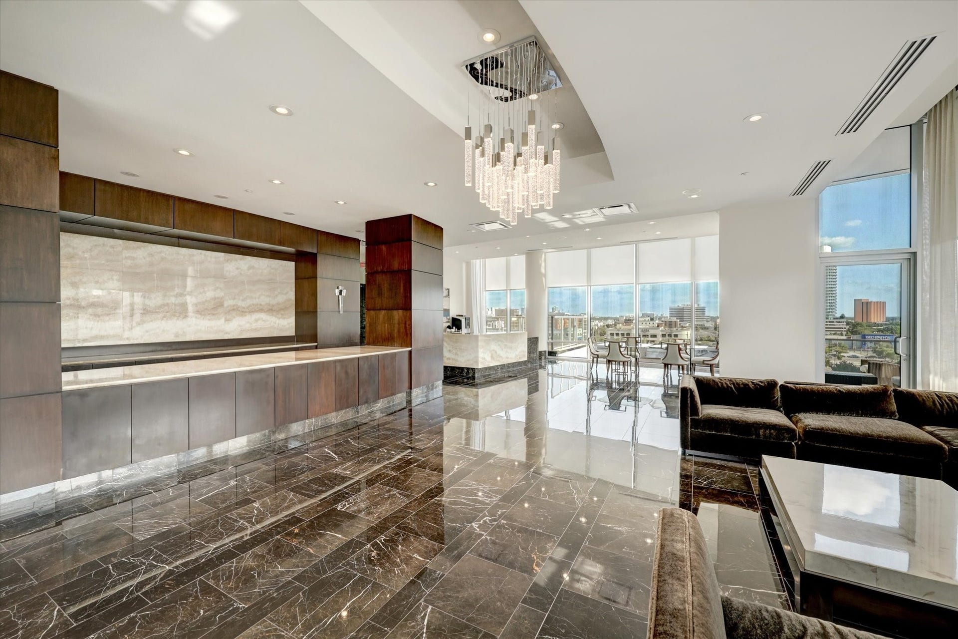 2727 Kirby Drive, #13E, Houston, TX 77098 Secondary lounge with marble flooring, floor-to-ceiling windows, and contemporary lighting.