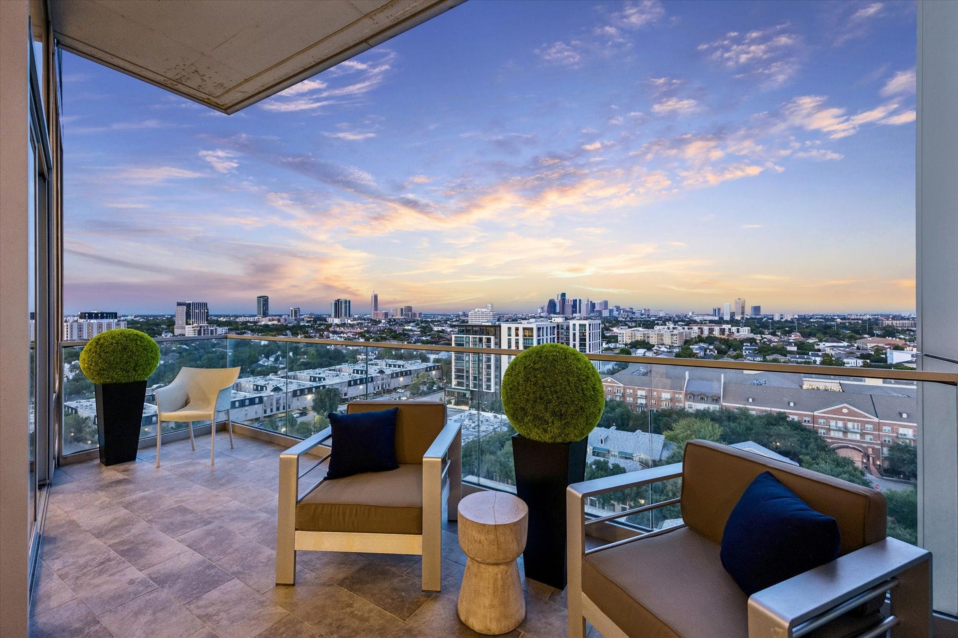 [Balcony] Step out onto the private, expansive balcony to enjoy sweeping views of the River Oaks area and the downtown skyline.