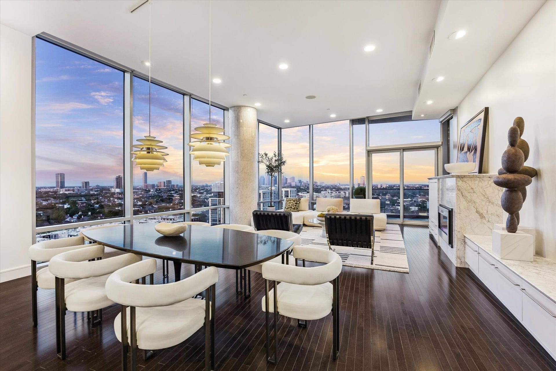 2727 Kirby Drive, #13E, Houston, TX 77098 Open-concept living and dining area framed by floor-to-ceiling windows, hardwood floors, and expansive city views.